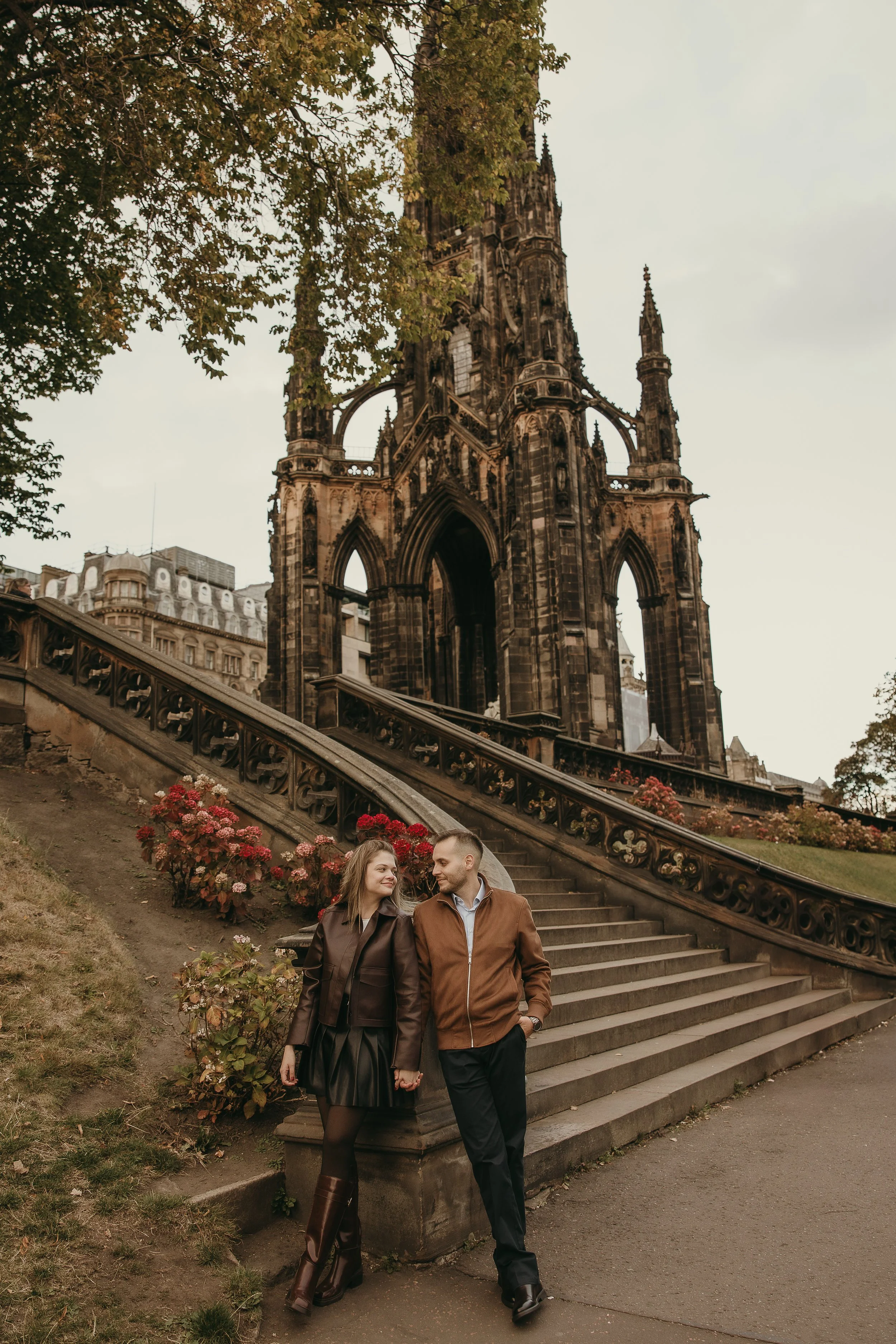 Romantic proposal photography in Edinburgh with couple celebrating and laughing together