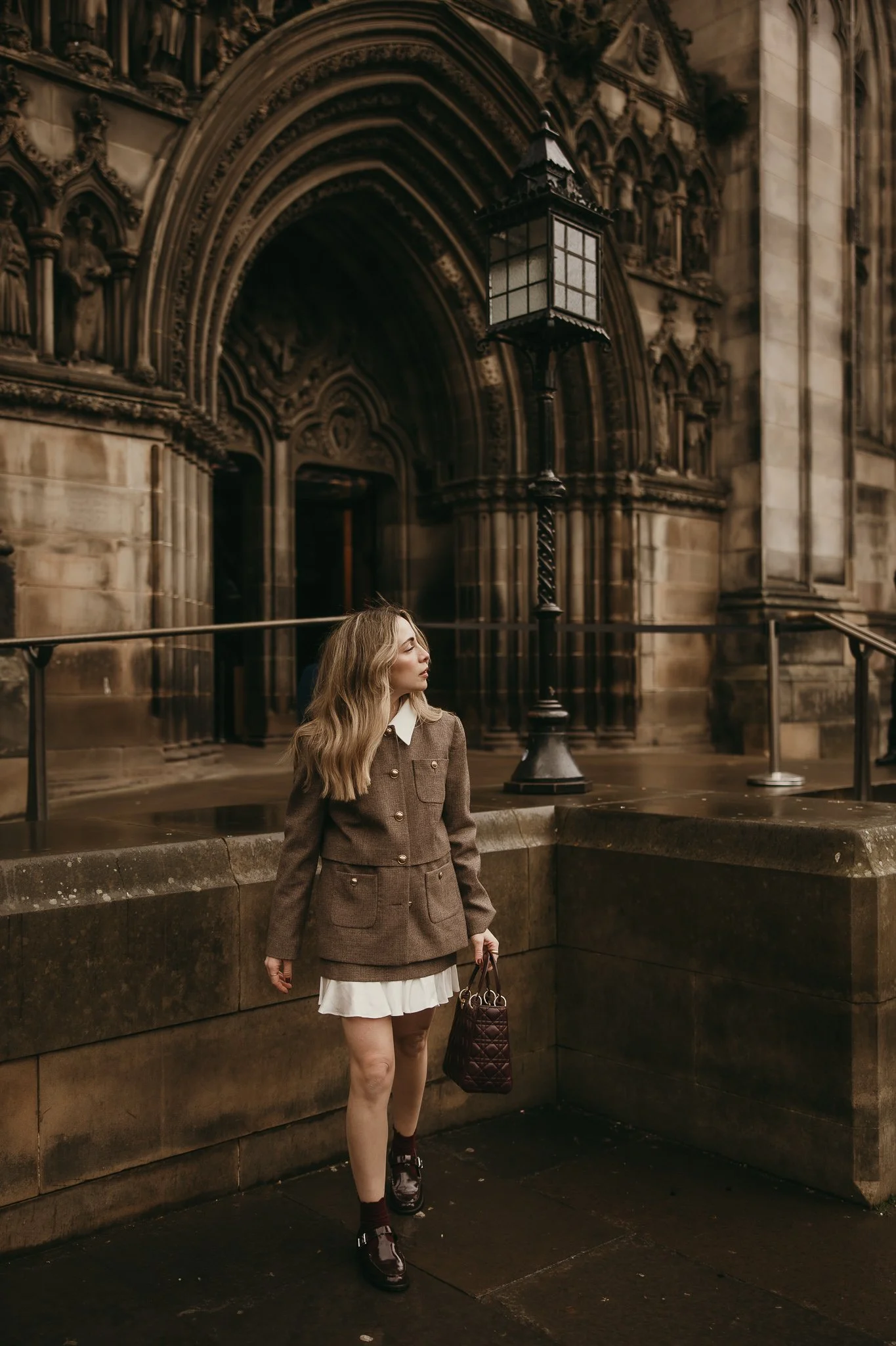 Female tourist enjoying her trip to Edinburgh during a natural solo portrait session.