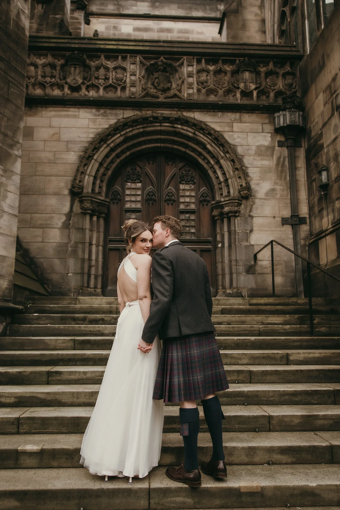 newlyweds at the steps posing for the portraits