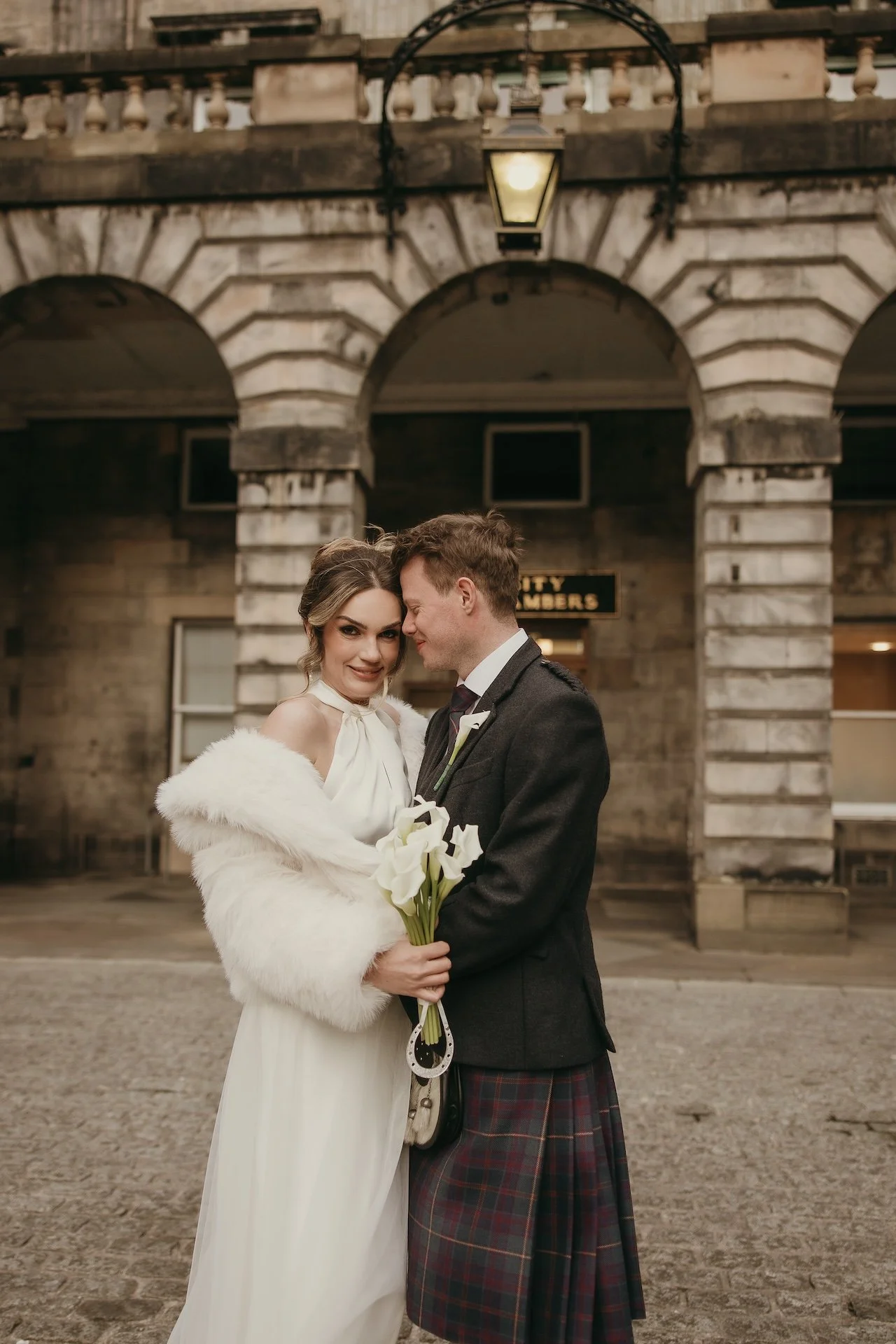 Bride resting her head on the groom’s shoulder during an intimate wedding moment