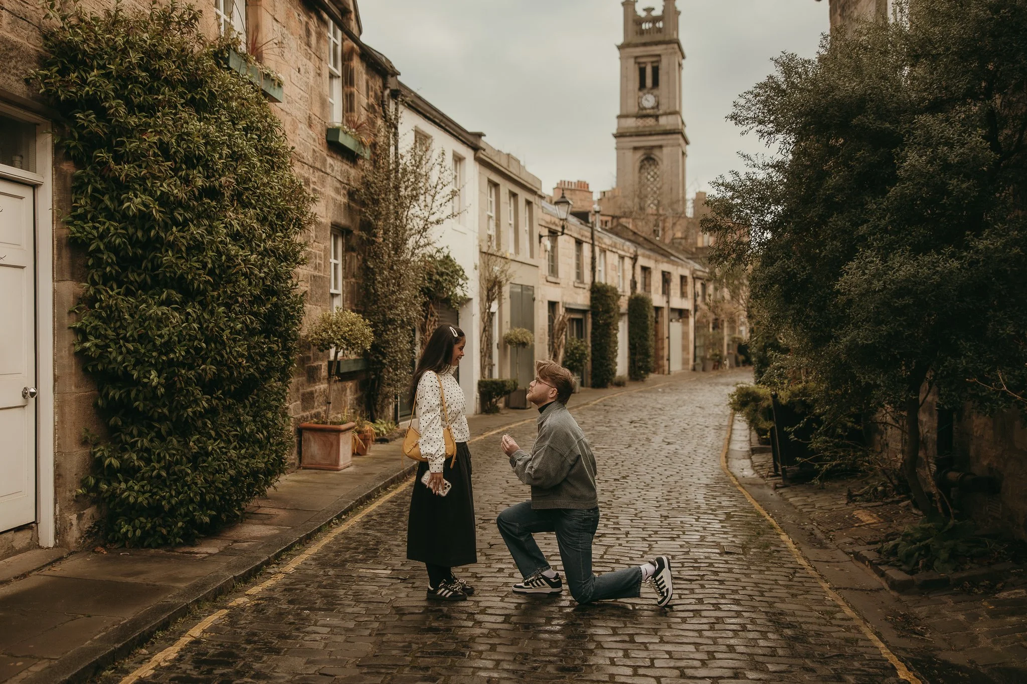 Happy couple celebrating engagement at Circus Lane Edinburgh with soft natural light