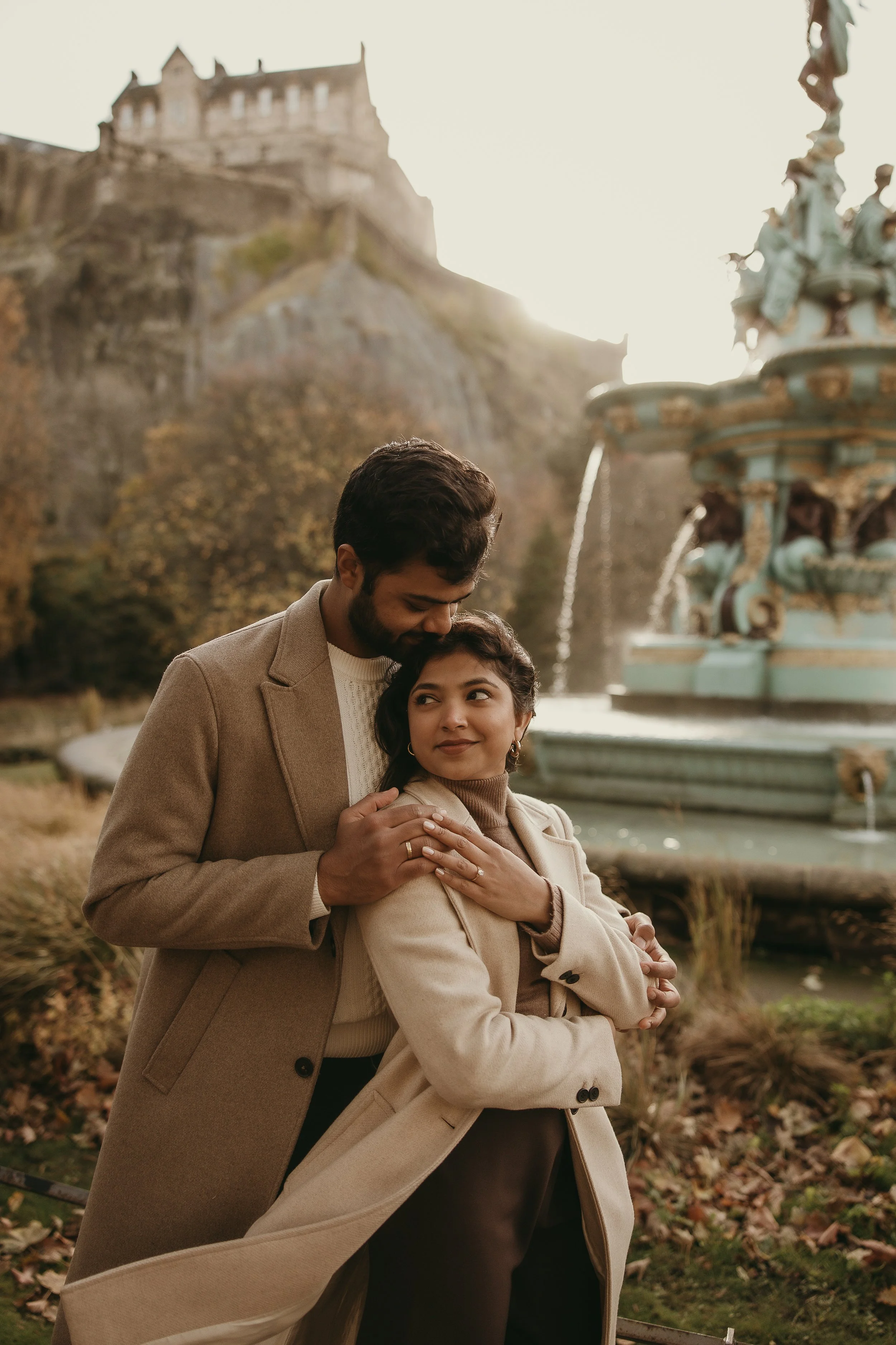 Natural proposal photography in Edinburgh with couple laughing after saying yes