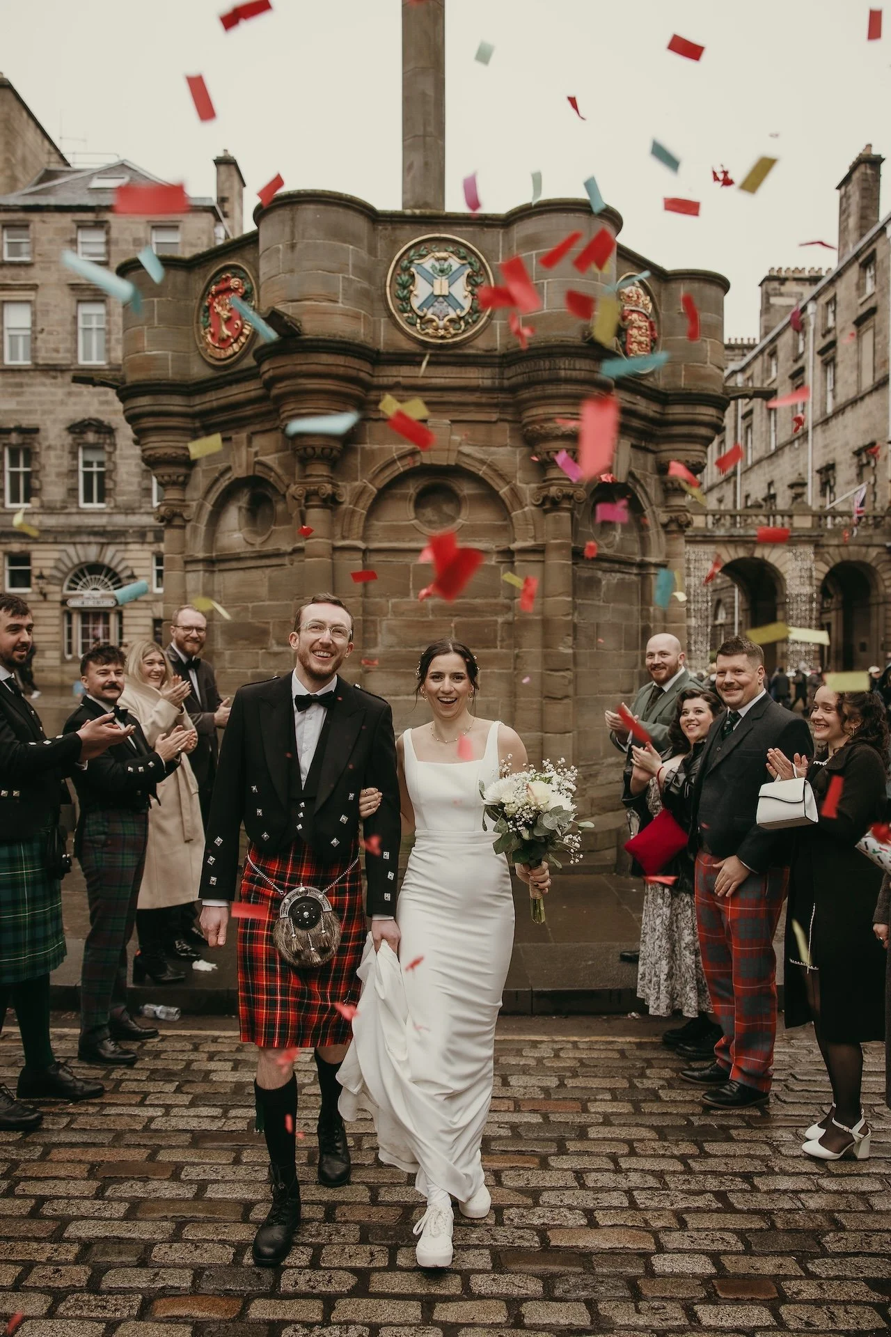 Bride and groom laughing together after their wedding ceremony in Edinburgh