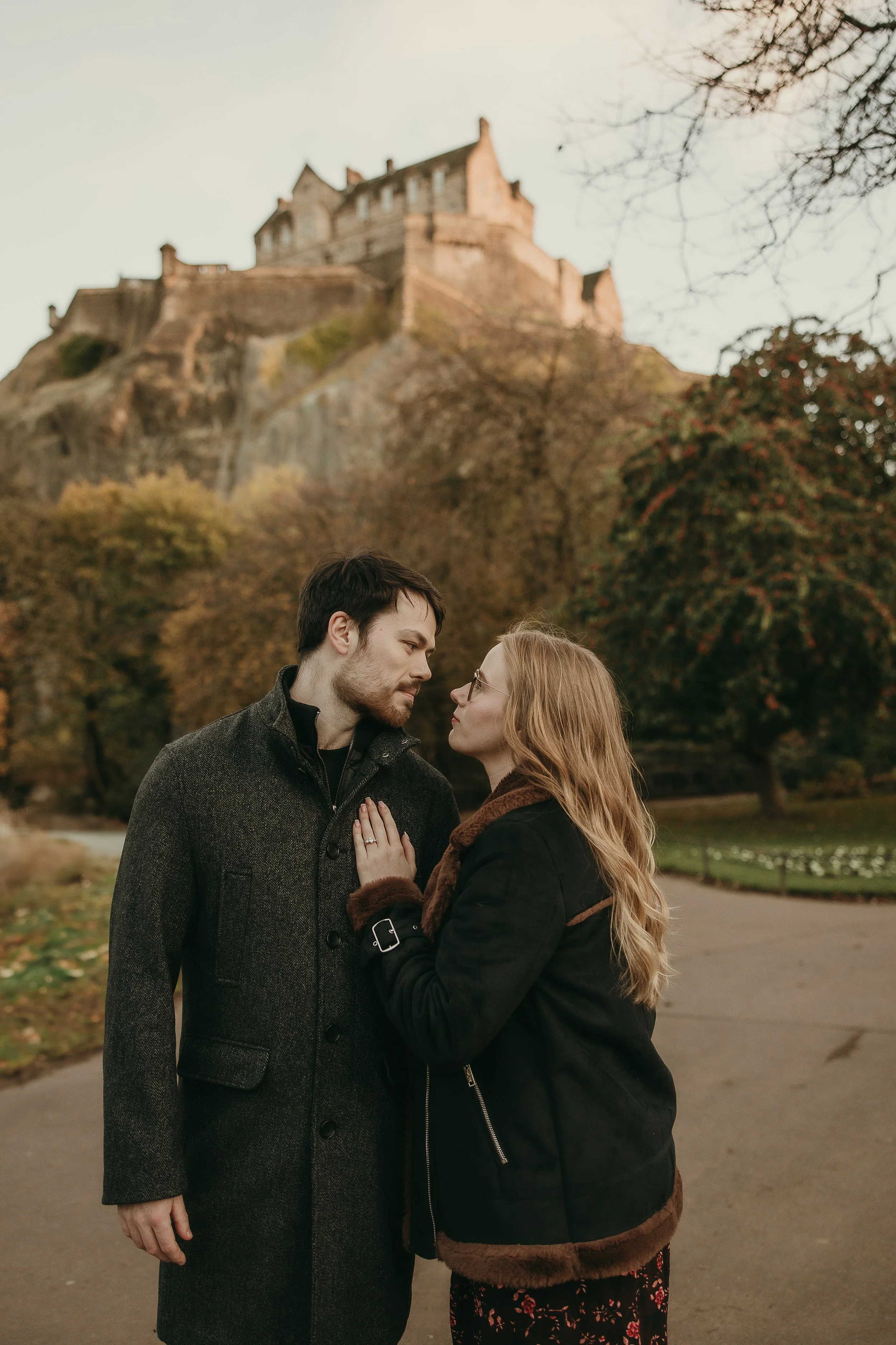 Happy couple celebrating engagement during romantic proposal photoshoot in Edinburgh