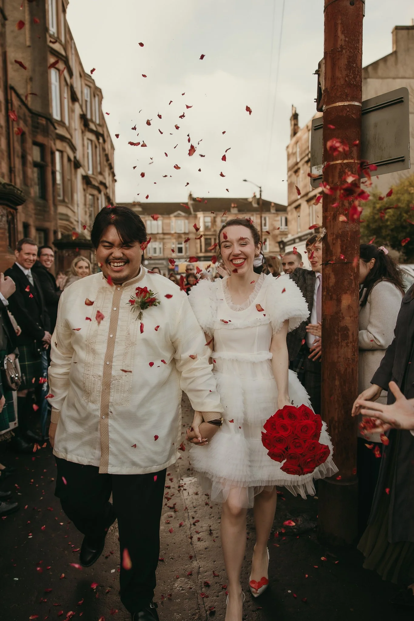 Newly married couple exiting Re:Hope Church surrounded by cheering guests