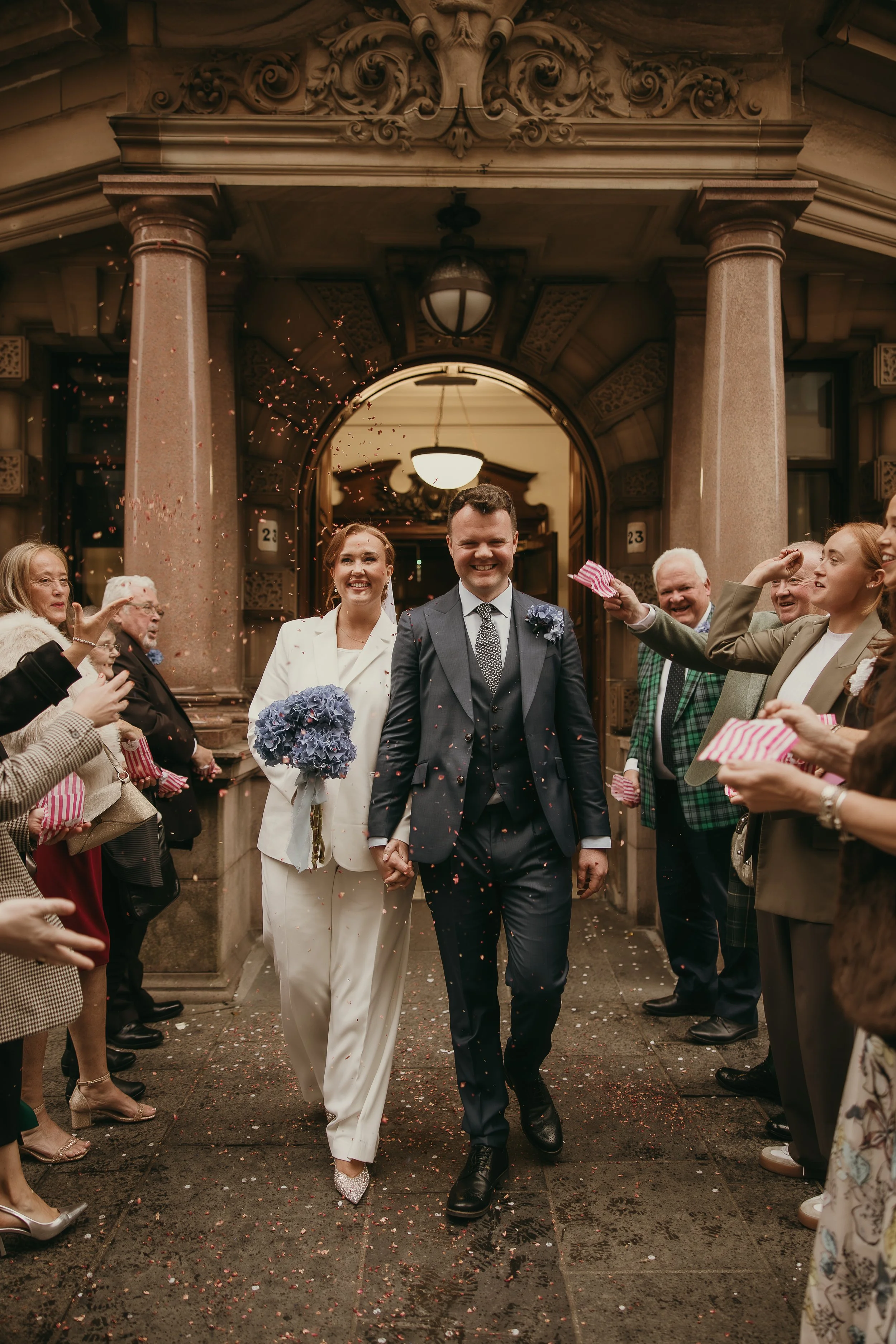 Romantic just married couple outside Glasgow City Chambers after a small wedding