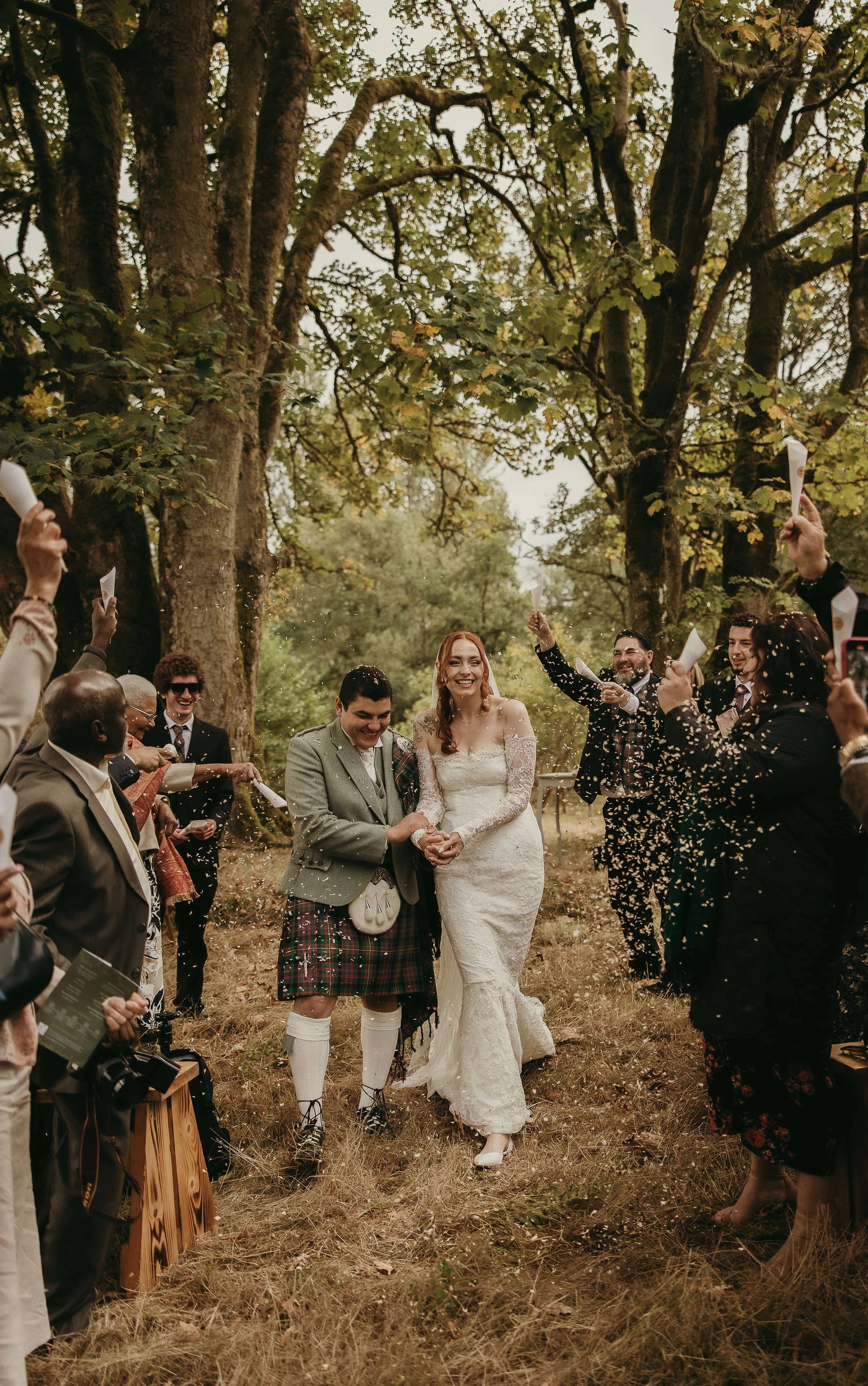 Newly married couple walking through grounds of Penicuik Estate