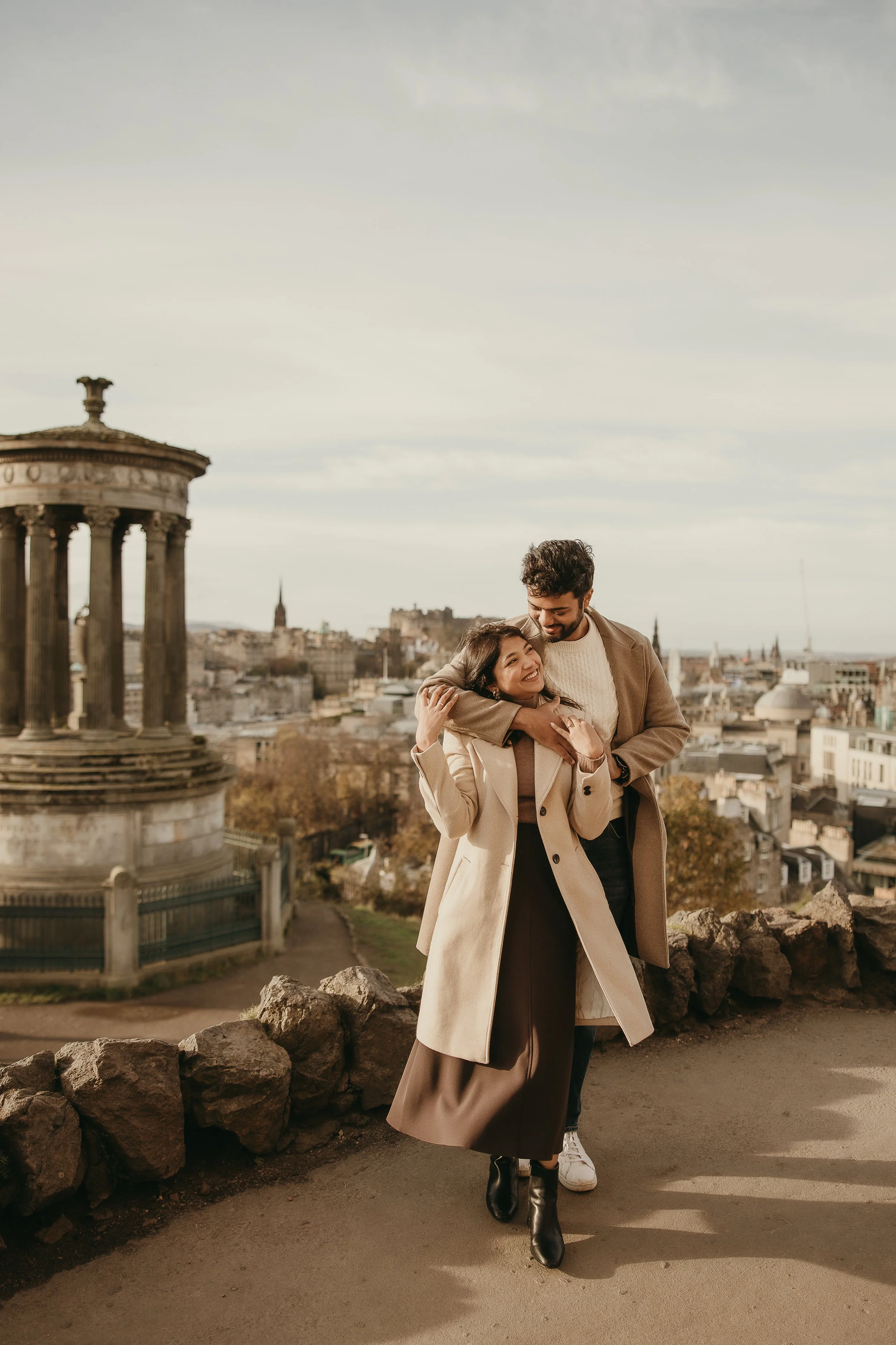 Just engaged couple walking through Edinburgh streets during proposal photoshoot