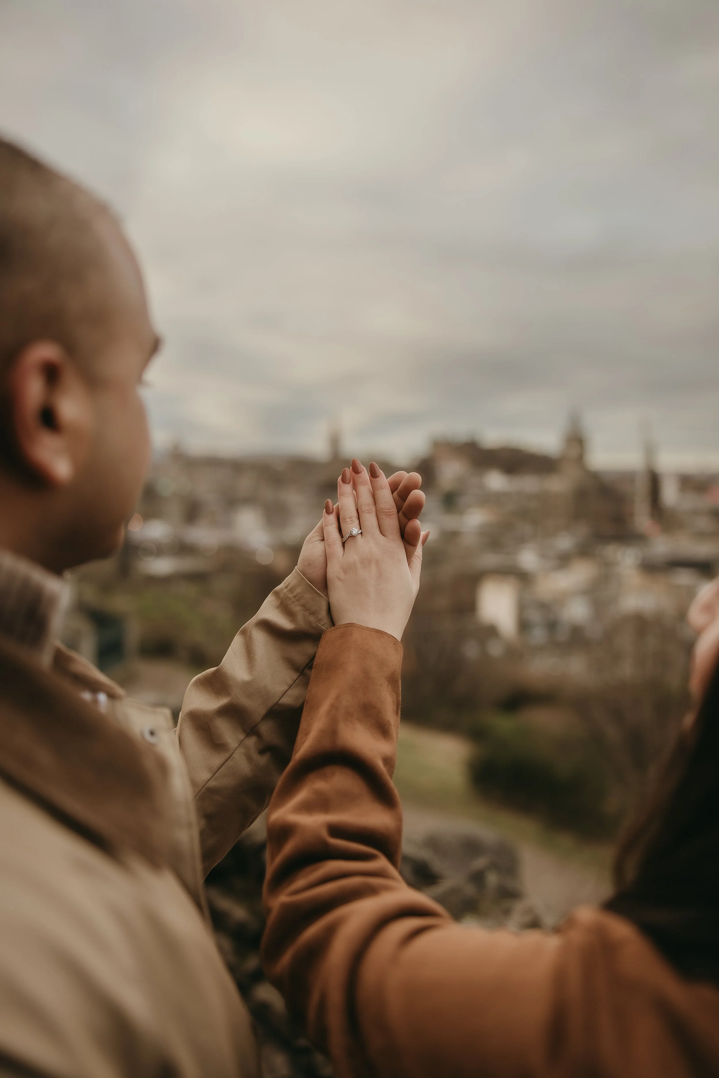 Romantic proposal photoshoot in Edinburgh with happy couple embracing after engagement