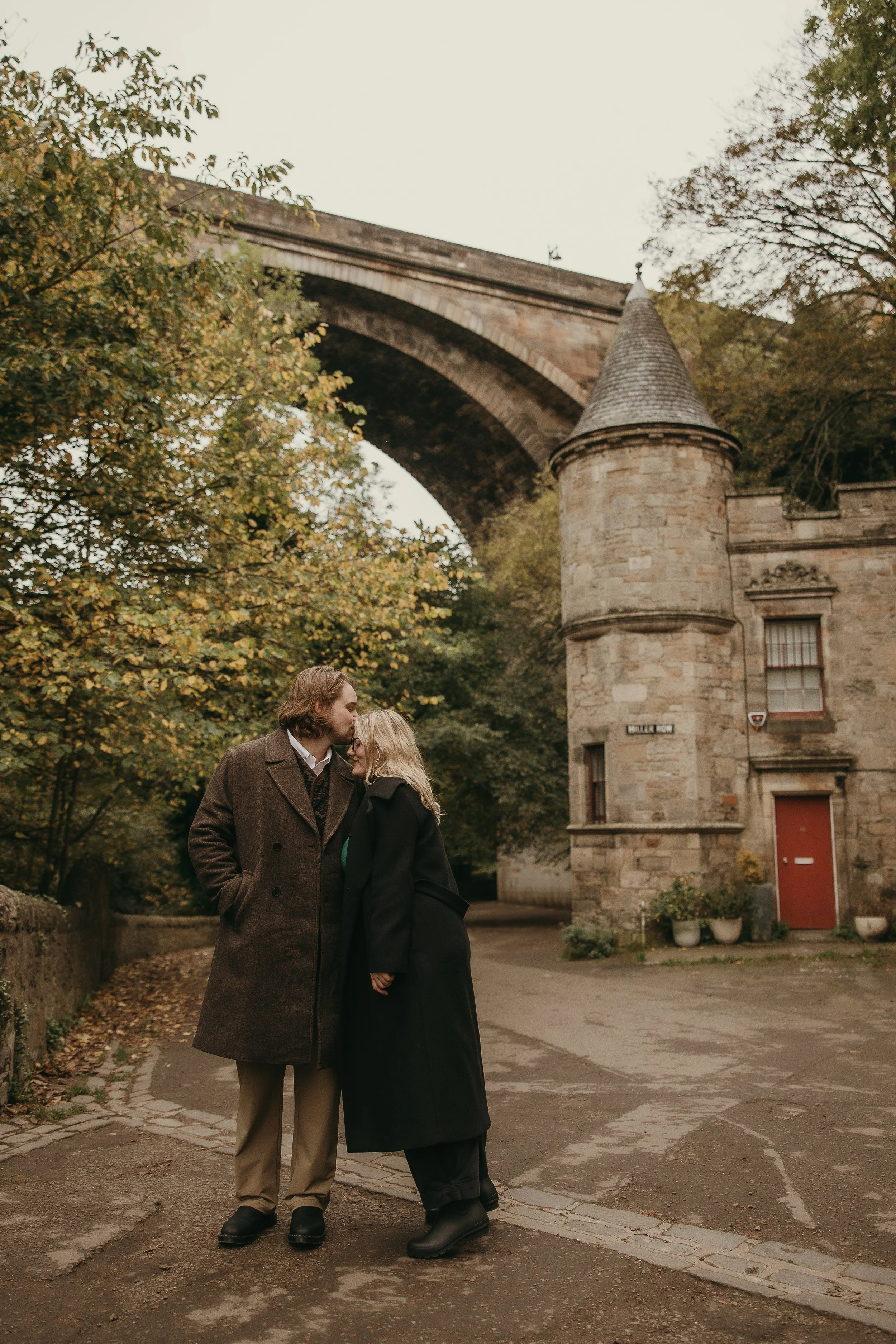 Romantic engagement photoshoot in Edinburgh with soft light and happy couple