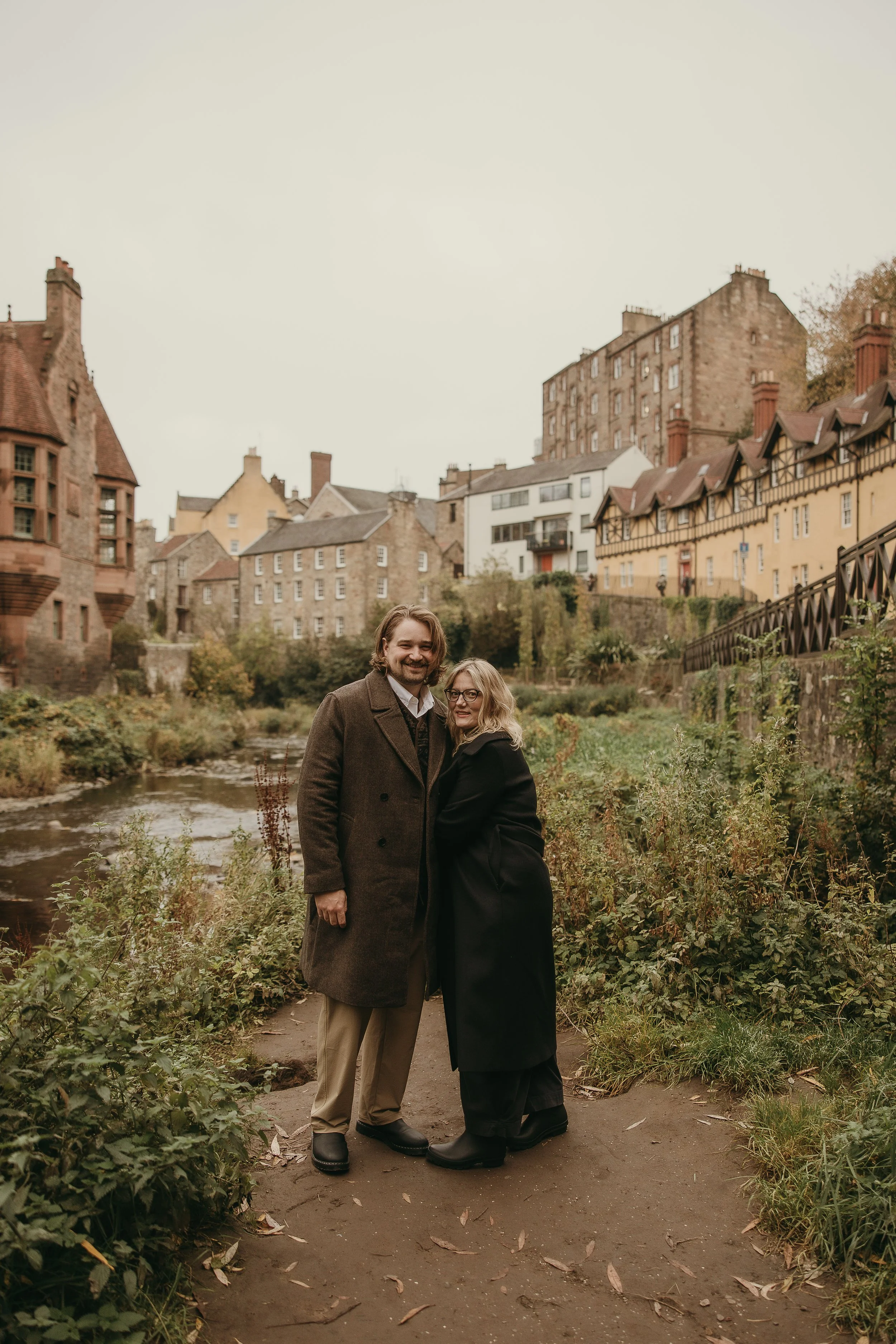 Couple celebrating engagement during Edinburgh proposal session with natural candid style