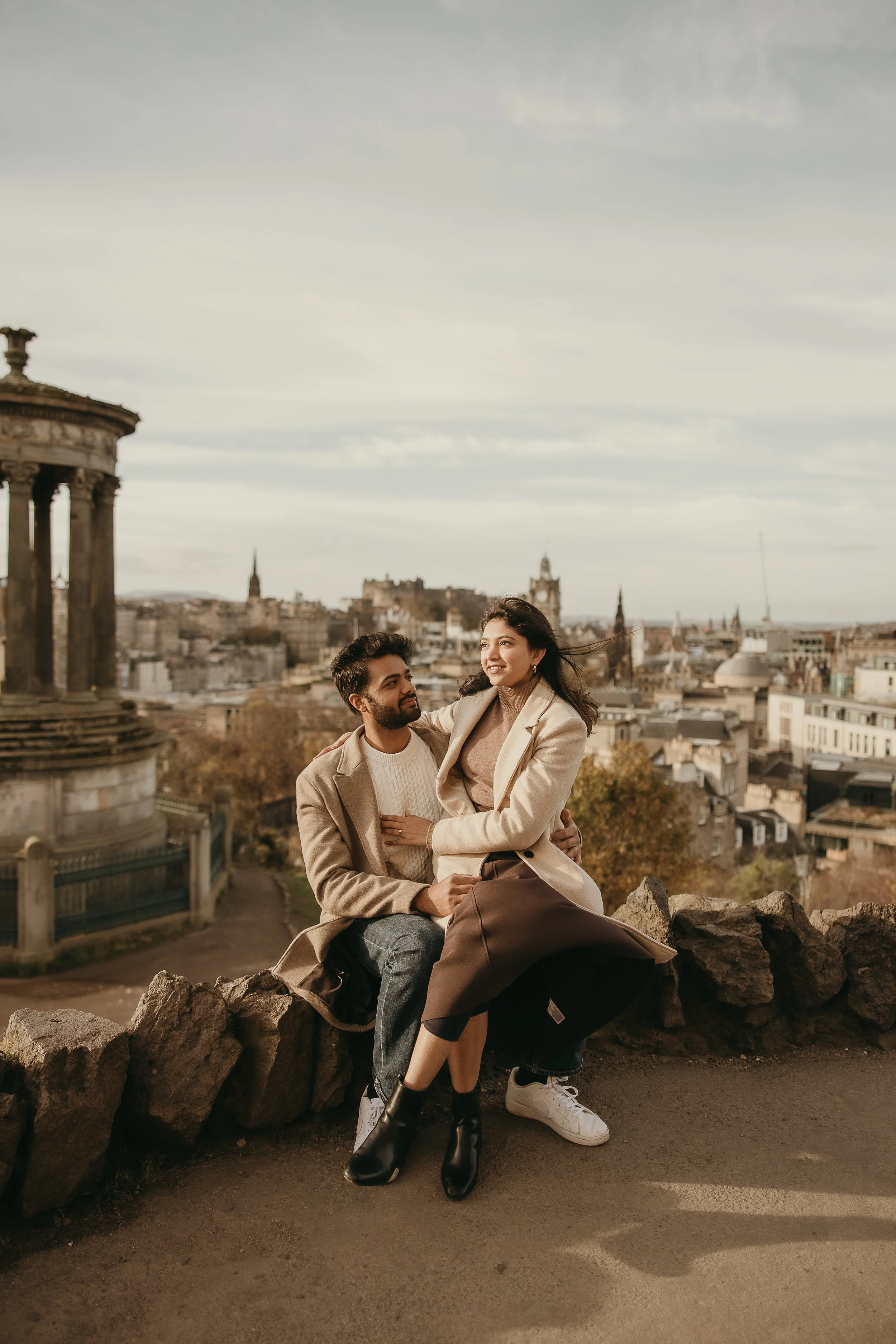 Romantic engagement photos in Edinburgh with soft golden hour light and joyful couple