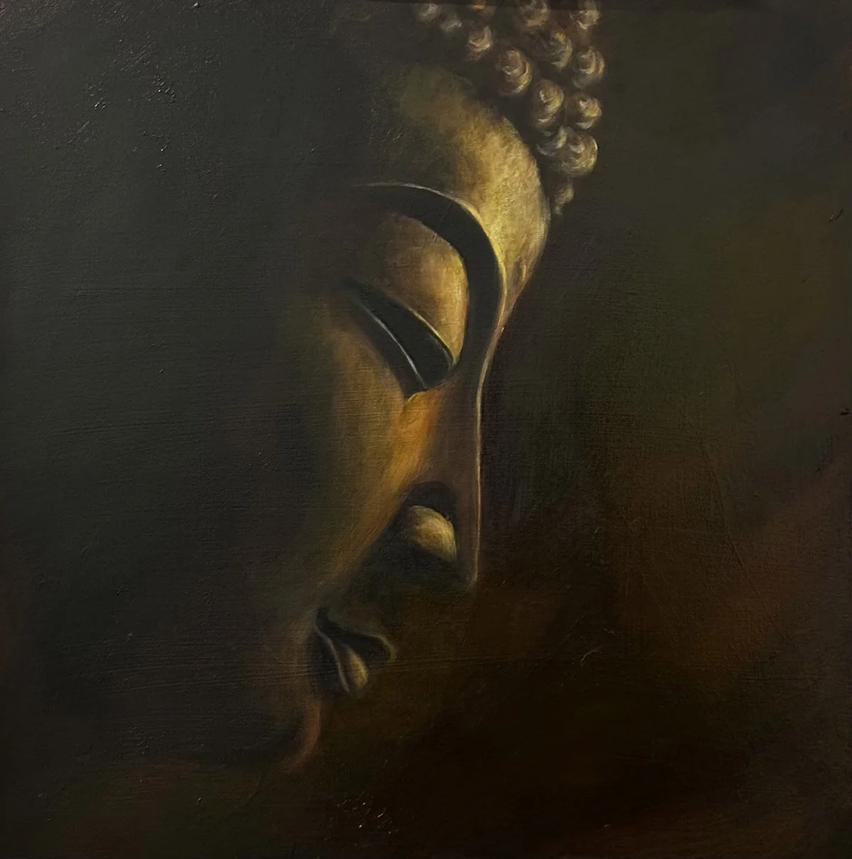 Close-up of a painted portrait of a serene Buddha with closed eyes, and warm earthy tones.
