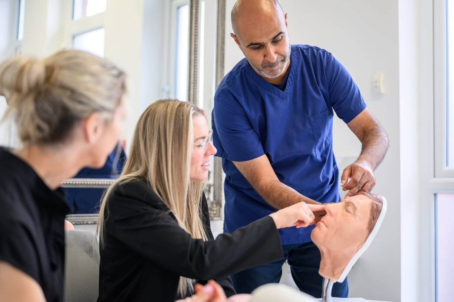 Trainer demonstrating injectable technique during course in Manchester