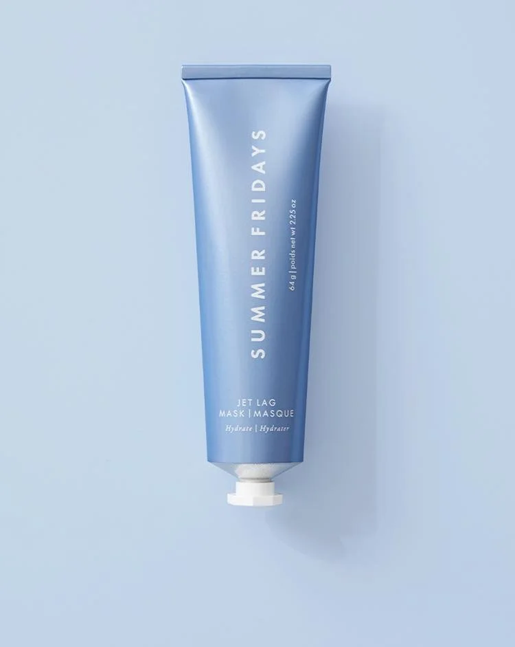 The Summer Fridays Jet Lag Mask tube standing upright on a pale blue background.