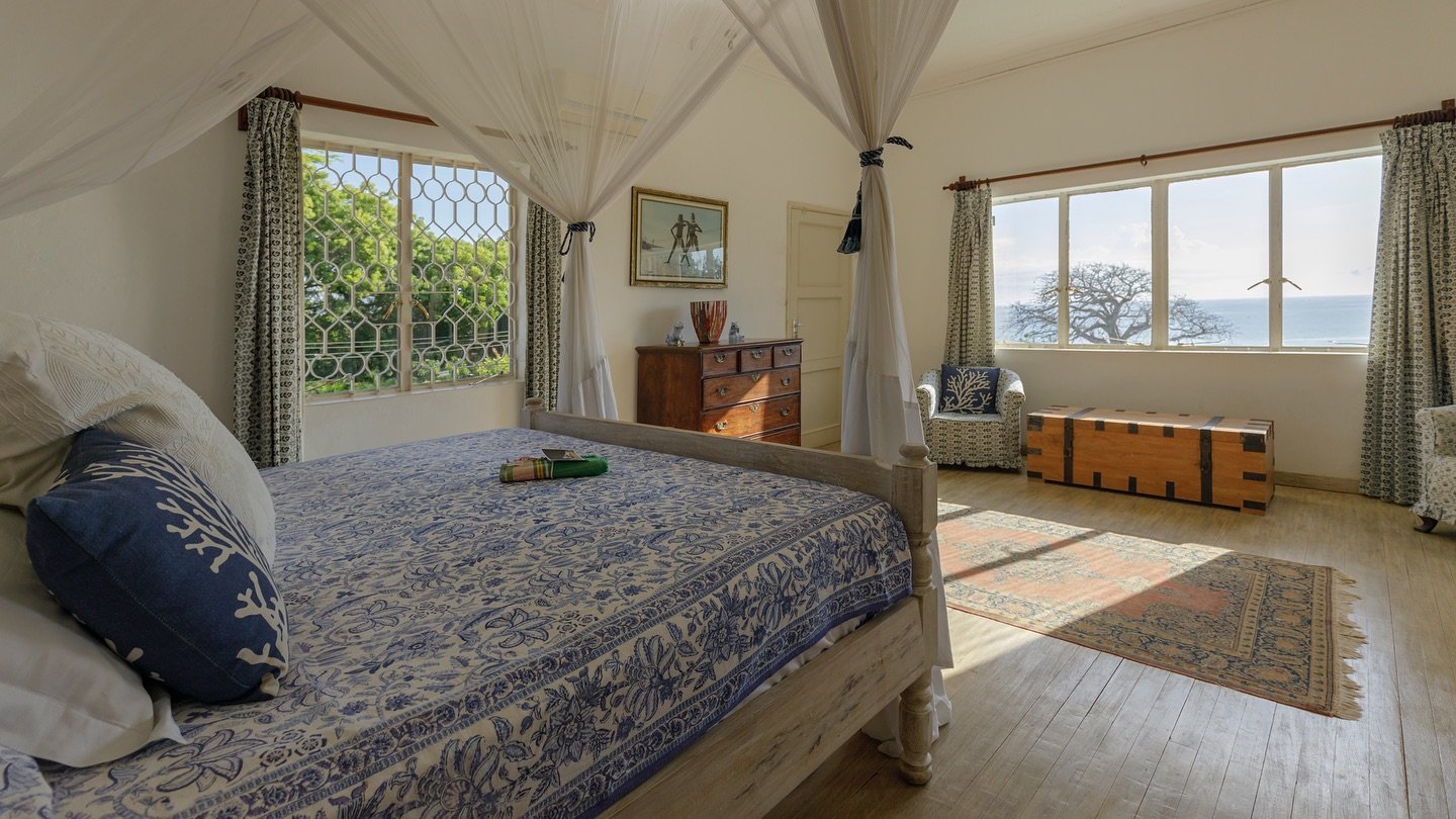 Set slightly back and raised up from the seafront, through wide lush gardens, the house offers expansive indoor and outdoor living spaces, cooling ocean breezes and distant sea views. The main house sleeps ten guests in five comfortable bedrooms, all