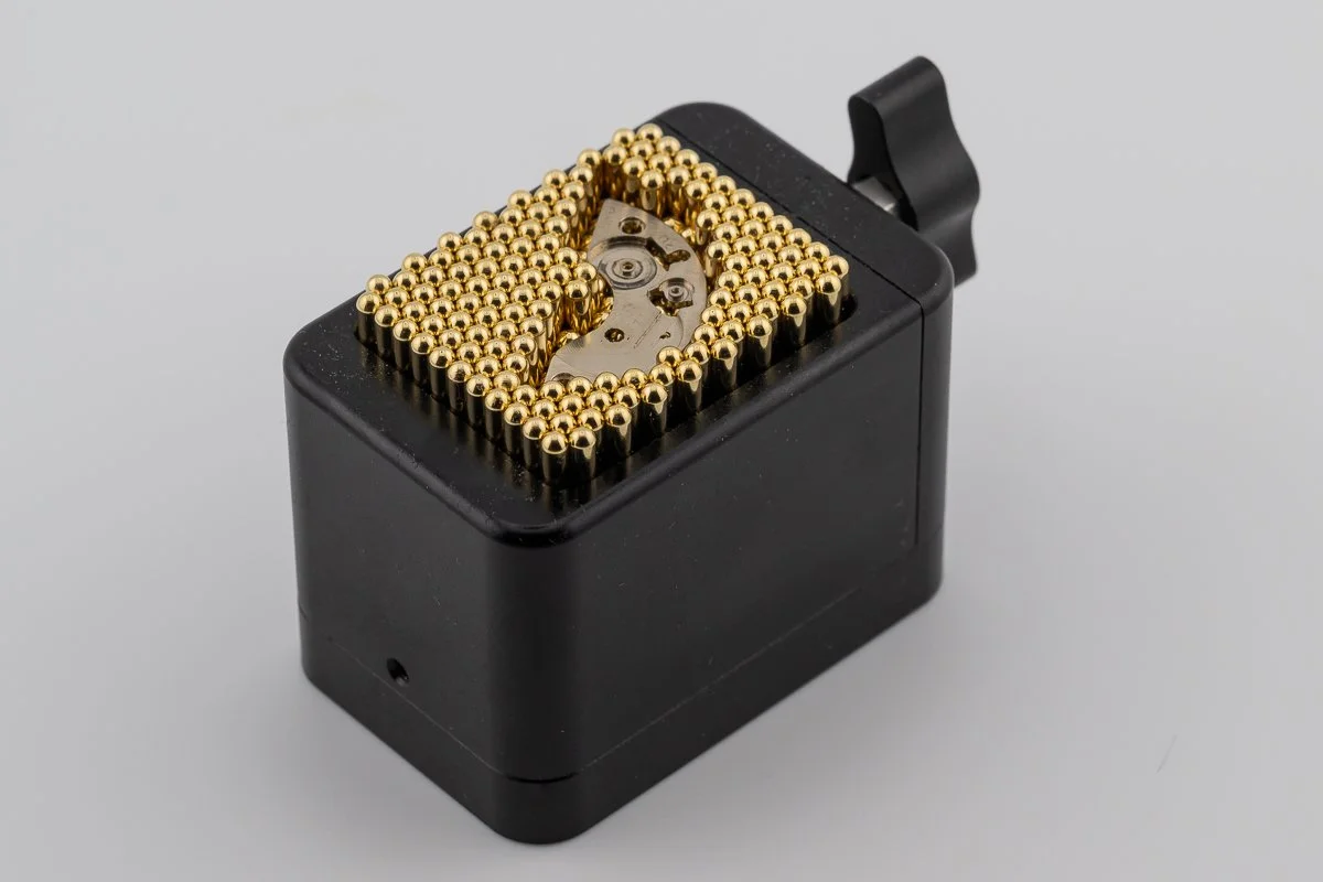 Contour clamp holding a watch barrel bridge