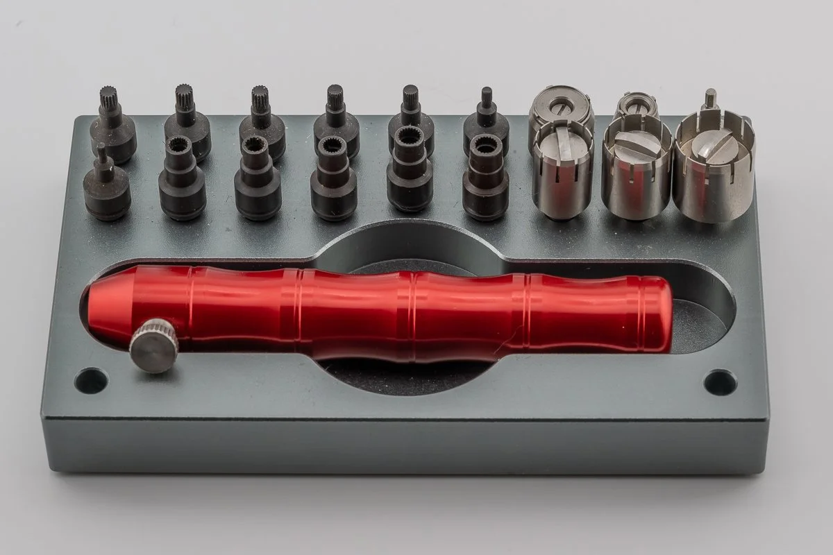 A basic wrench for threaded case tubes and pushers with various interchangeable splined heads