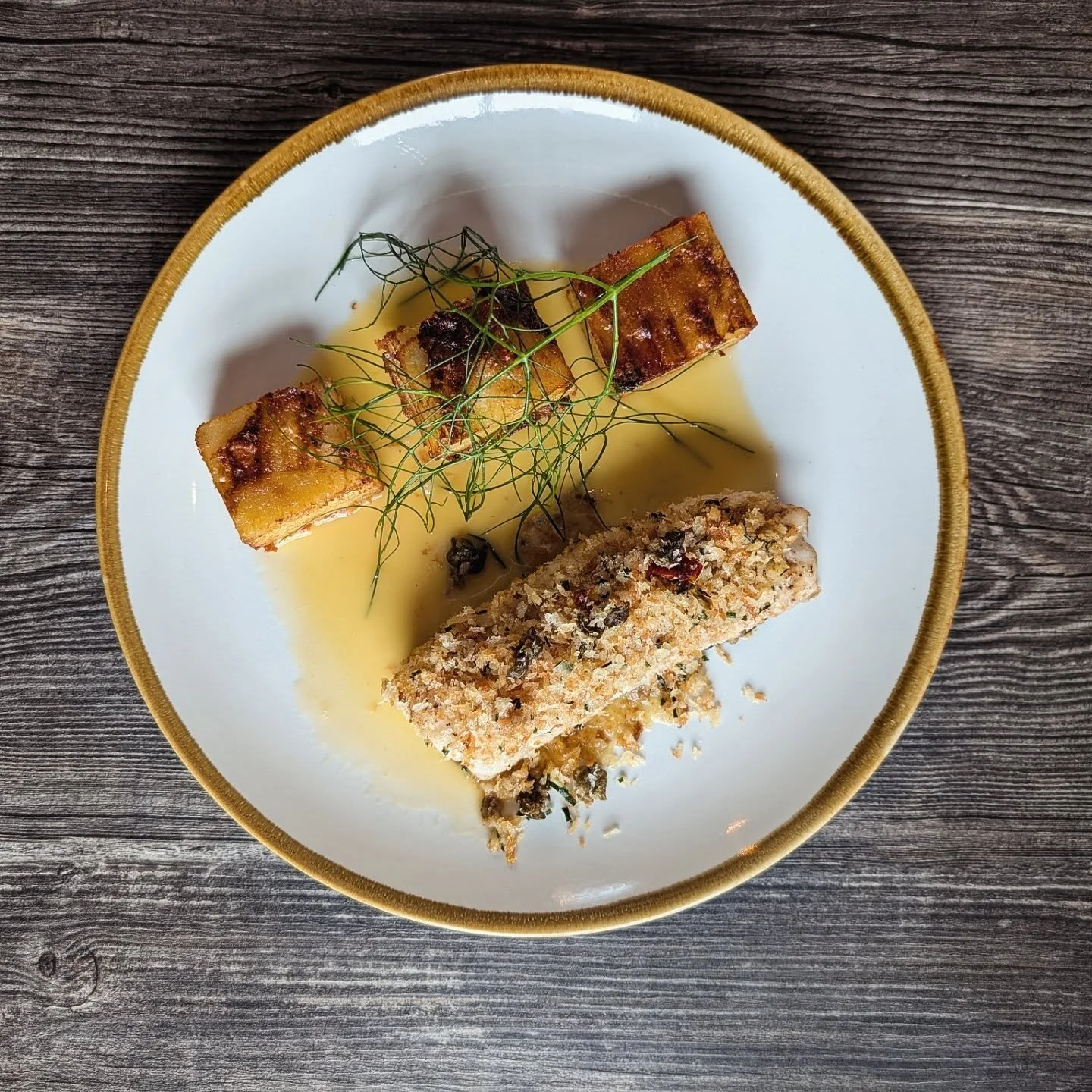 Fish special from last week's dinner menu.
Cod in lemon Beurre Blanc with crispy potato pav&eacute; and sundried tomato&amp; caper pangrattato .