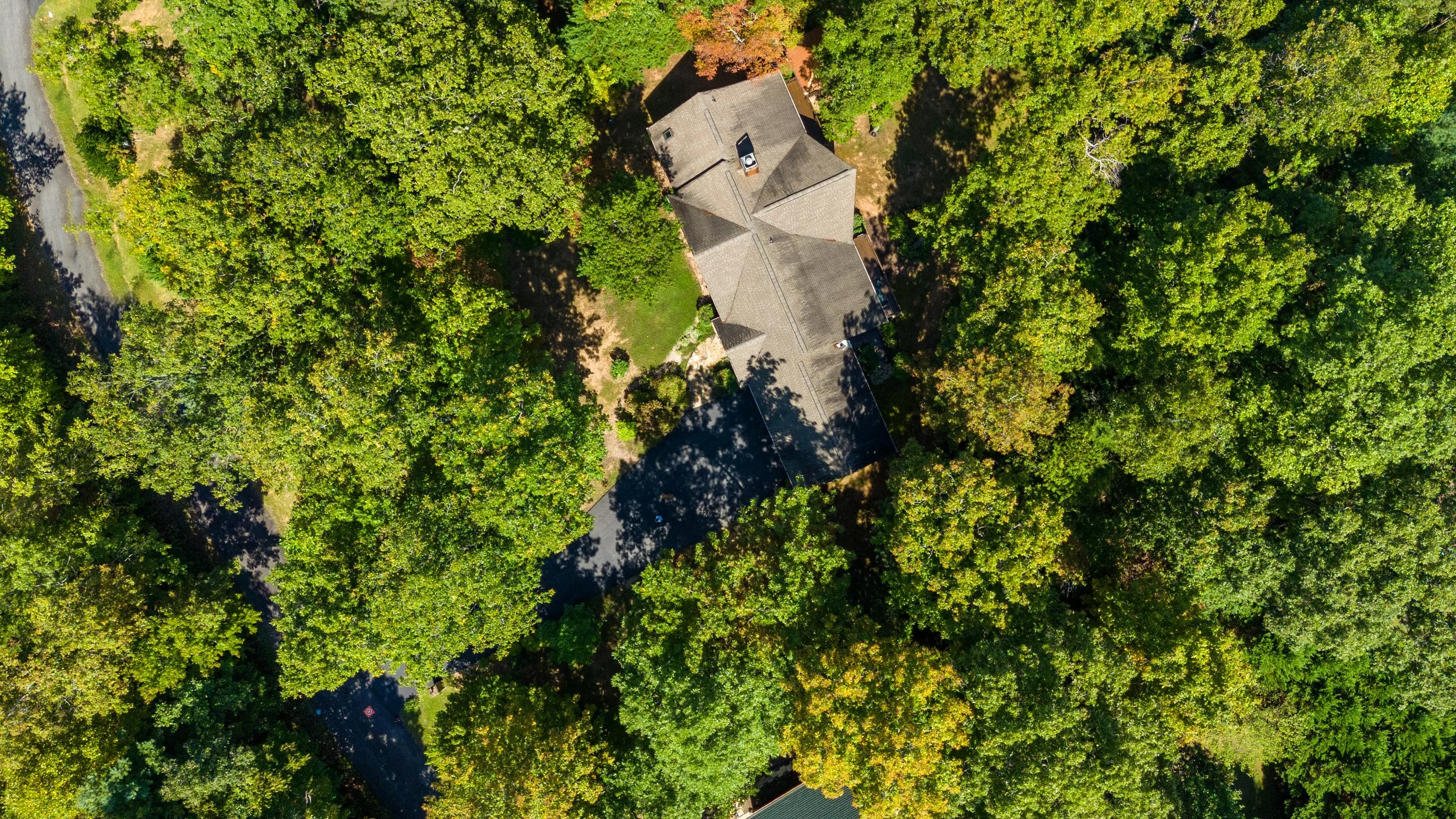 Aerial view looking directly down at a home in the woods in western north Carolina mountains.
