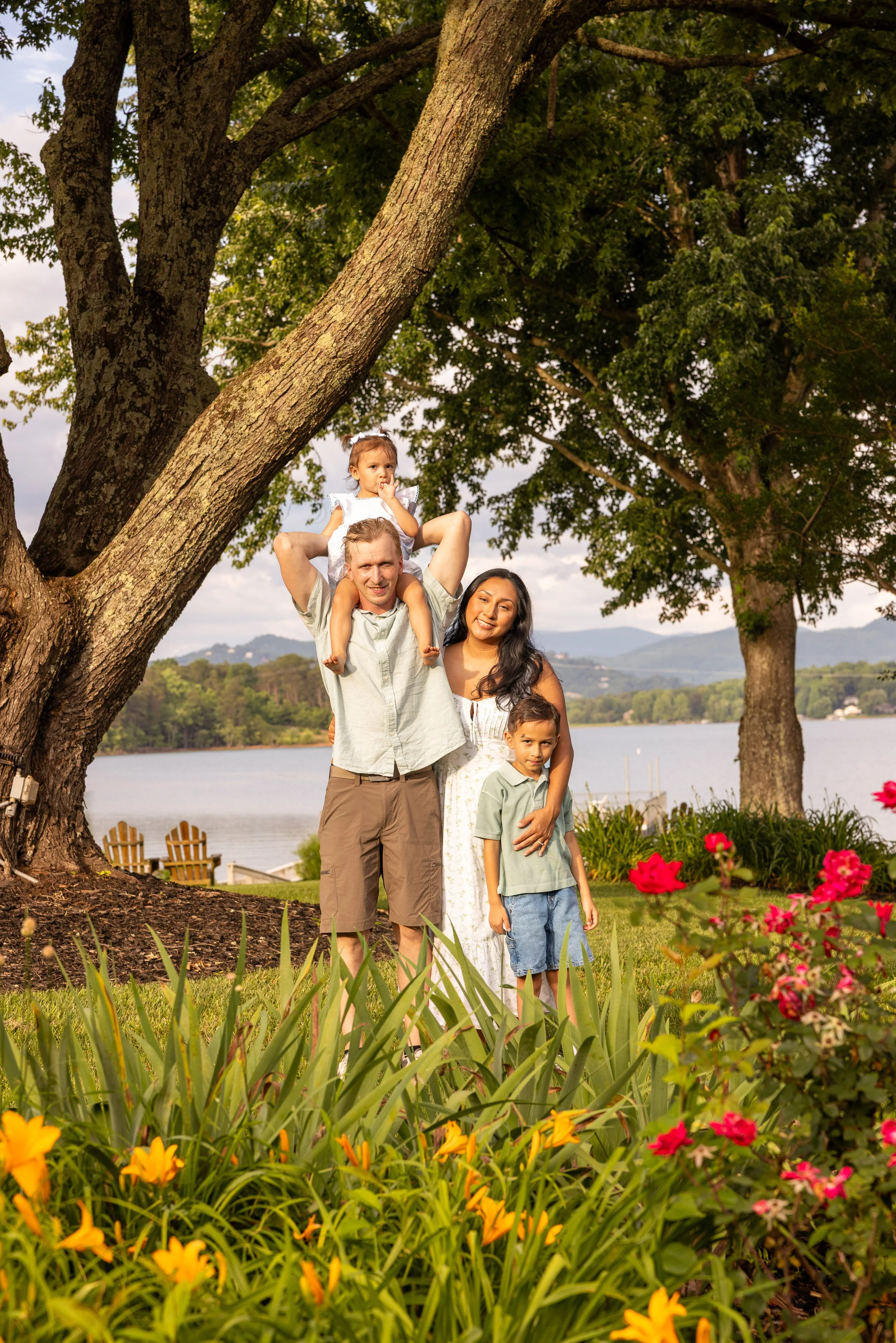 family posing for a fun photo in front of flowers