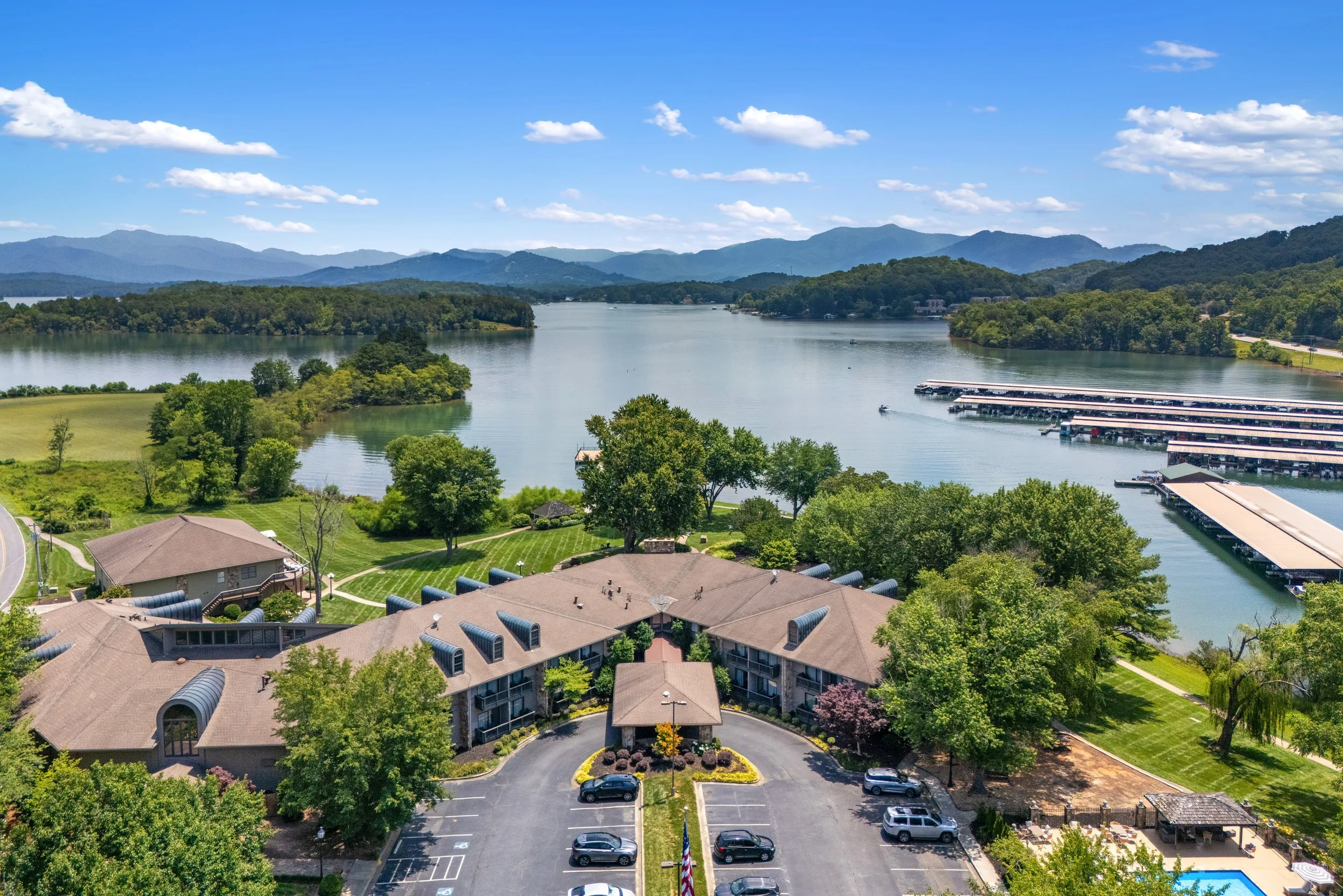 drone view of a resort with lake and mountains