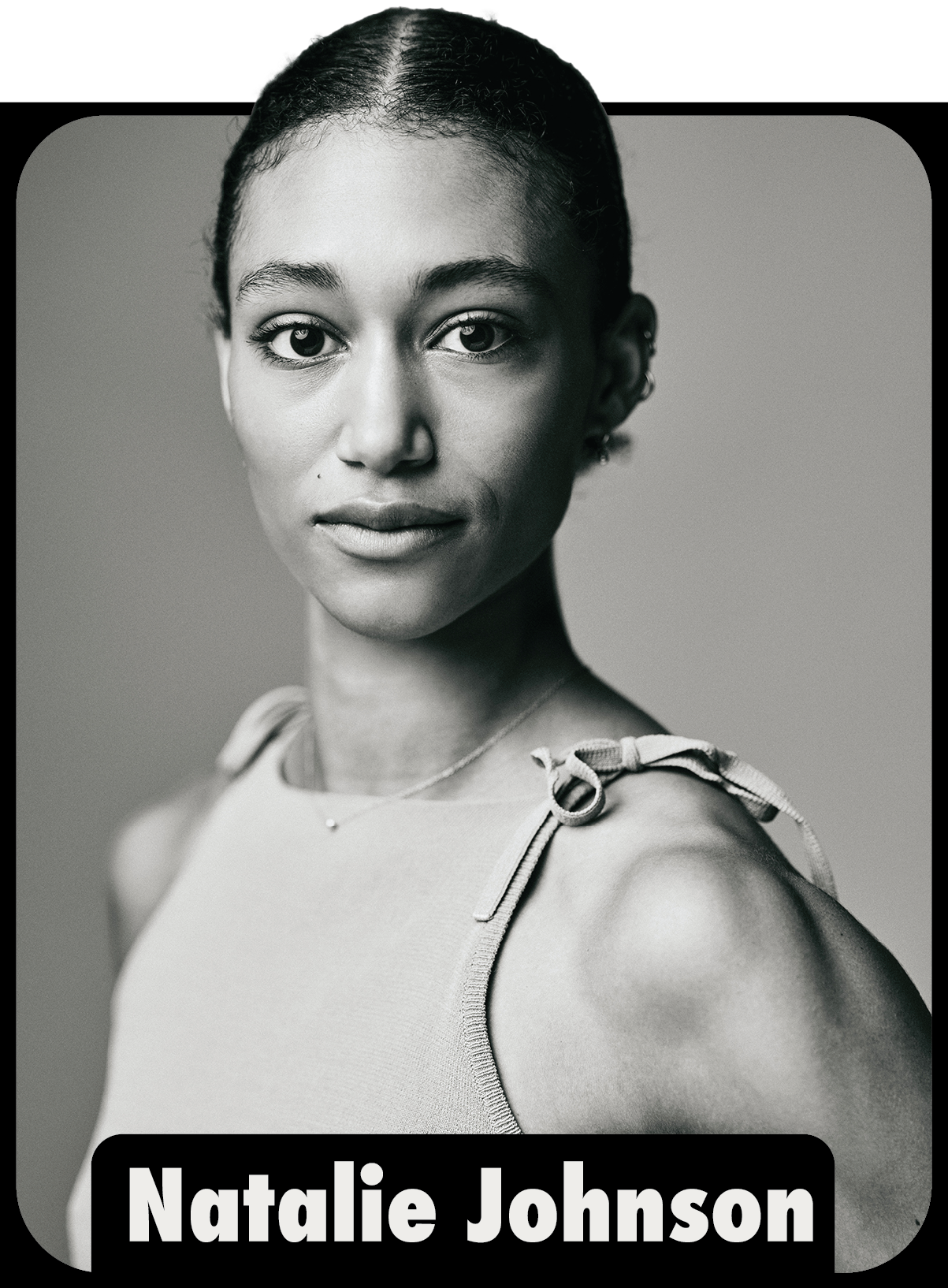 Black and white portrait of Natalie Johnson, an African American woman with short hair, wearing a sleeveless top with shoulder ties and a delicate necklace.