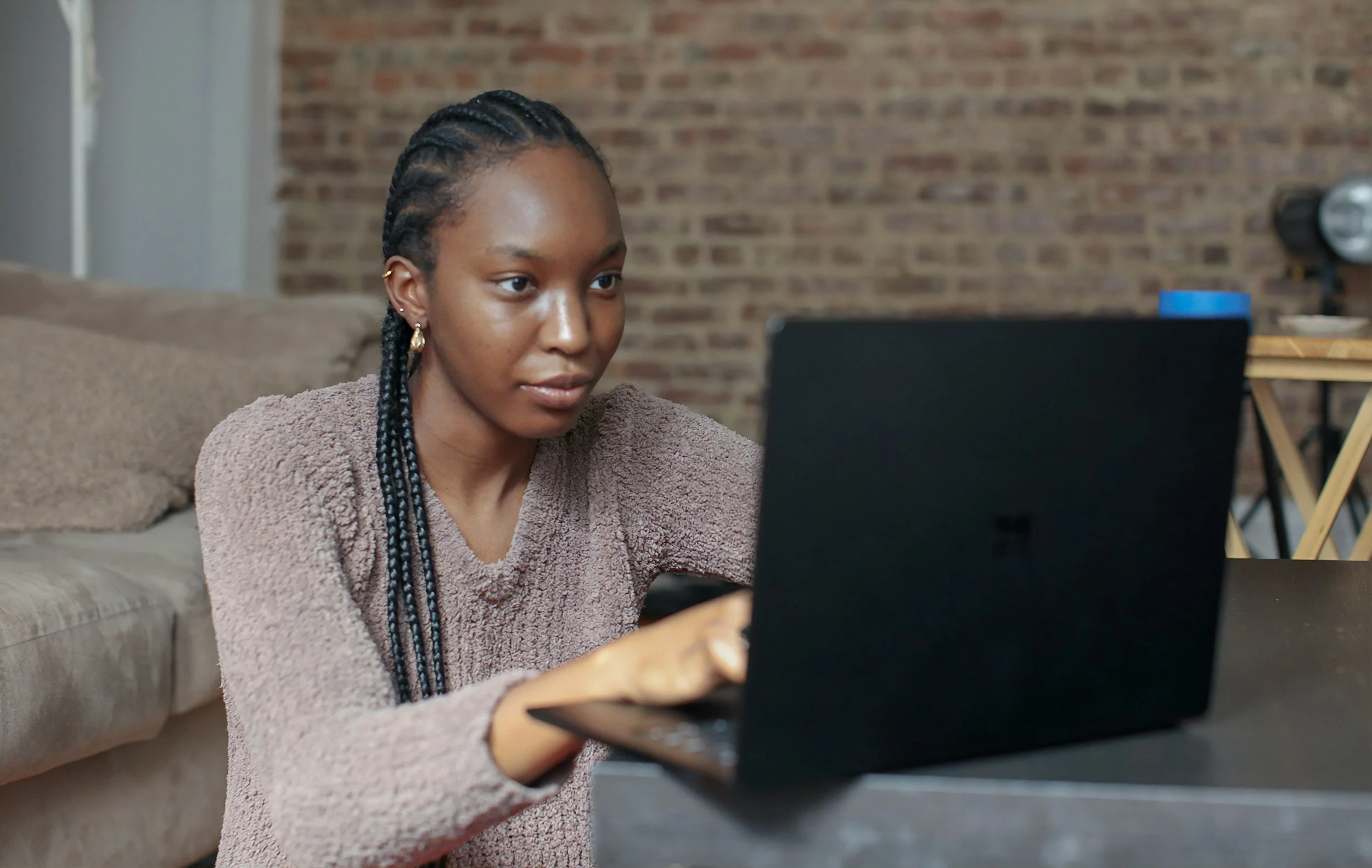 Woman on computer on coffee table