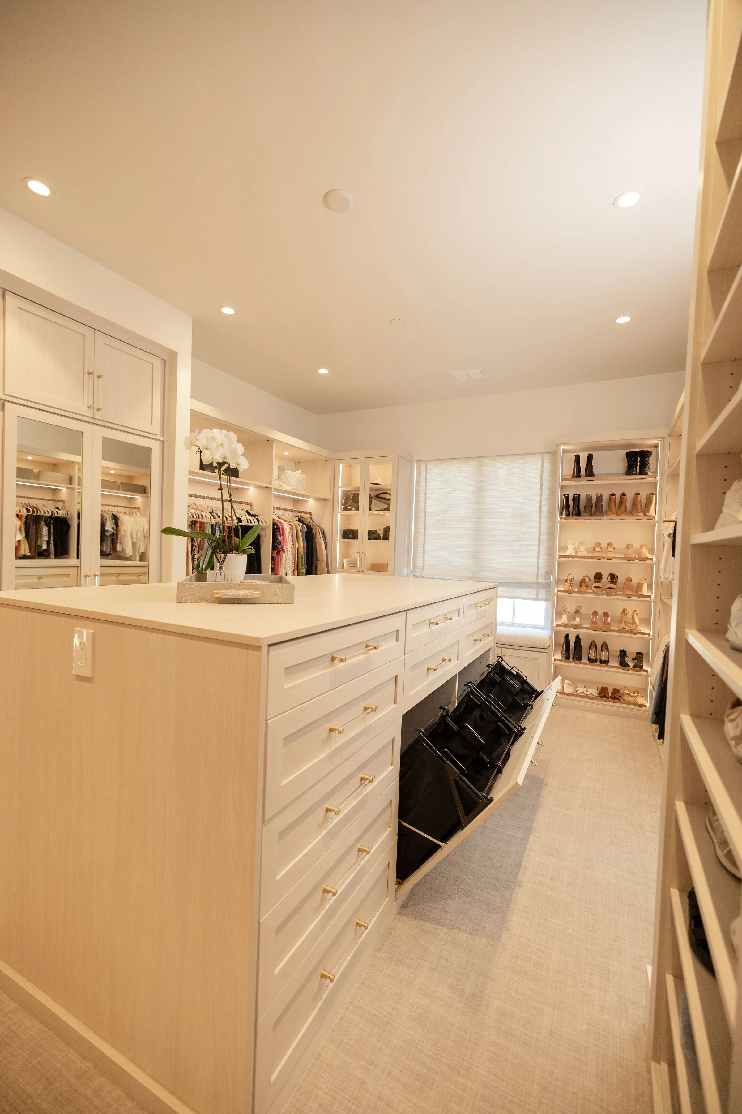 Walk-in closet with built-in drawers and lit shelving in a Sarasota home