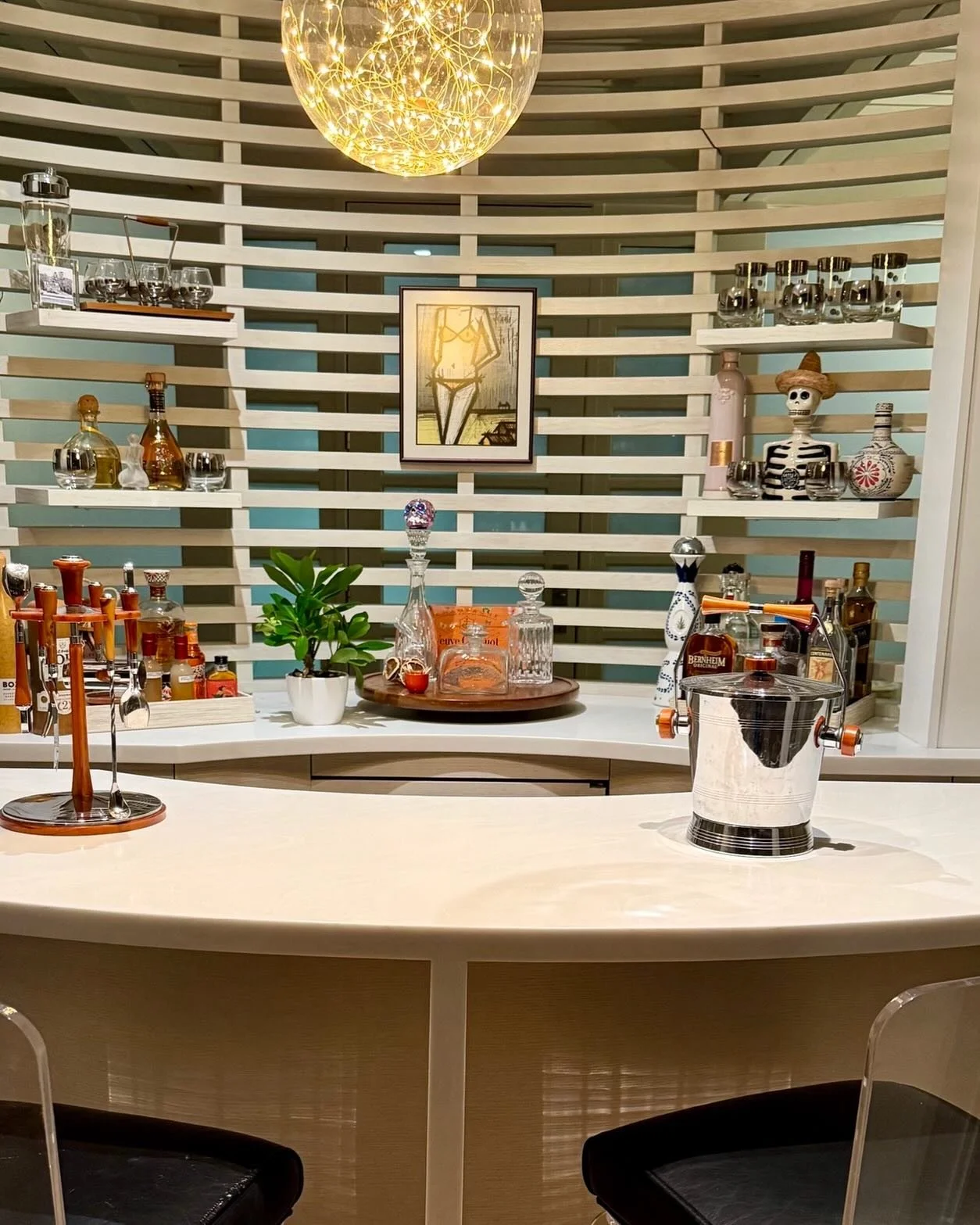 Bar Vibes➡️
MCM glassware, bakelite accessories, and an abundance of Tequila. Cozy home bar. 
Vintage Charles Hollis Jones lucite bar stools. 

#westchestermoms 
#homebars 
#vintagebarware