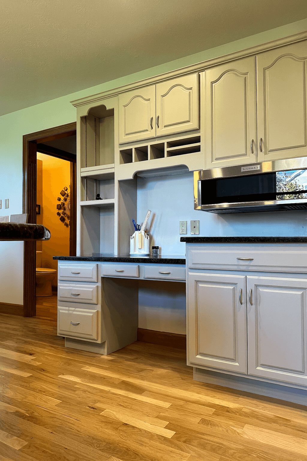 Refinished built‑in kitchen desk and cabinets in a soft neutral color with a smooth, furniture‑grade finish in Dayton, Ohio