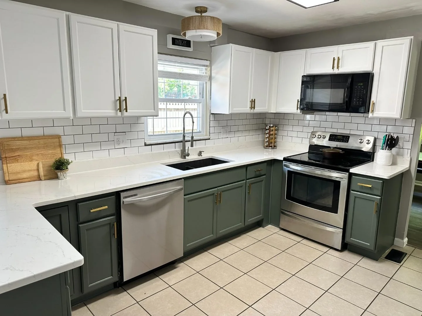 Two-tone kitchen cabinets with white uppers and green lowers (range view)