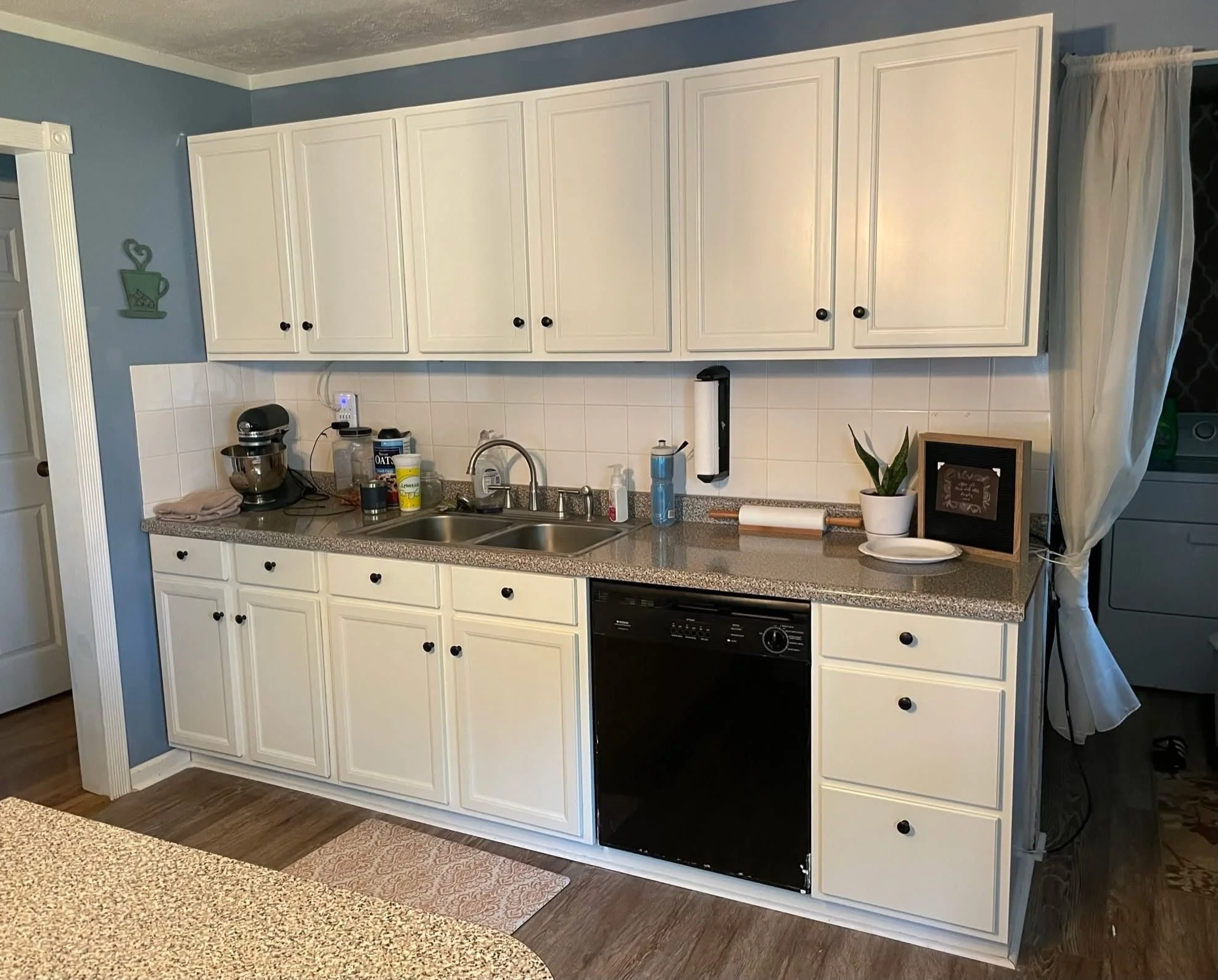 Alabaster white kitchen cabinets refinished by Craft & Revive in Dayton, OH, featuring a modern farmhouse design with black hardware.