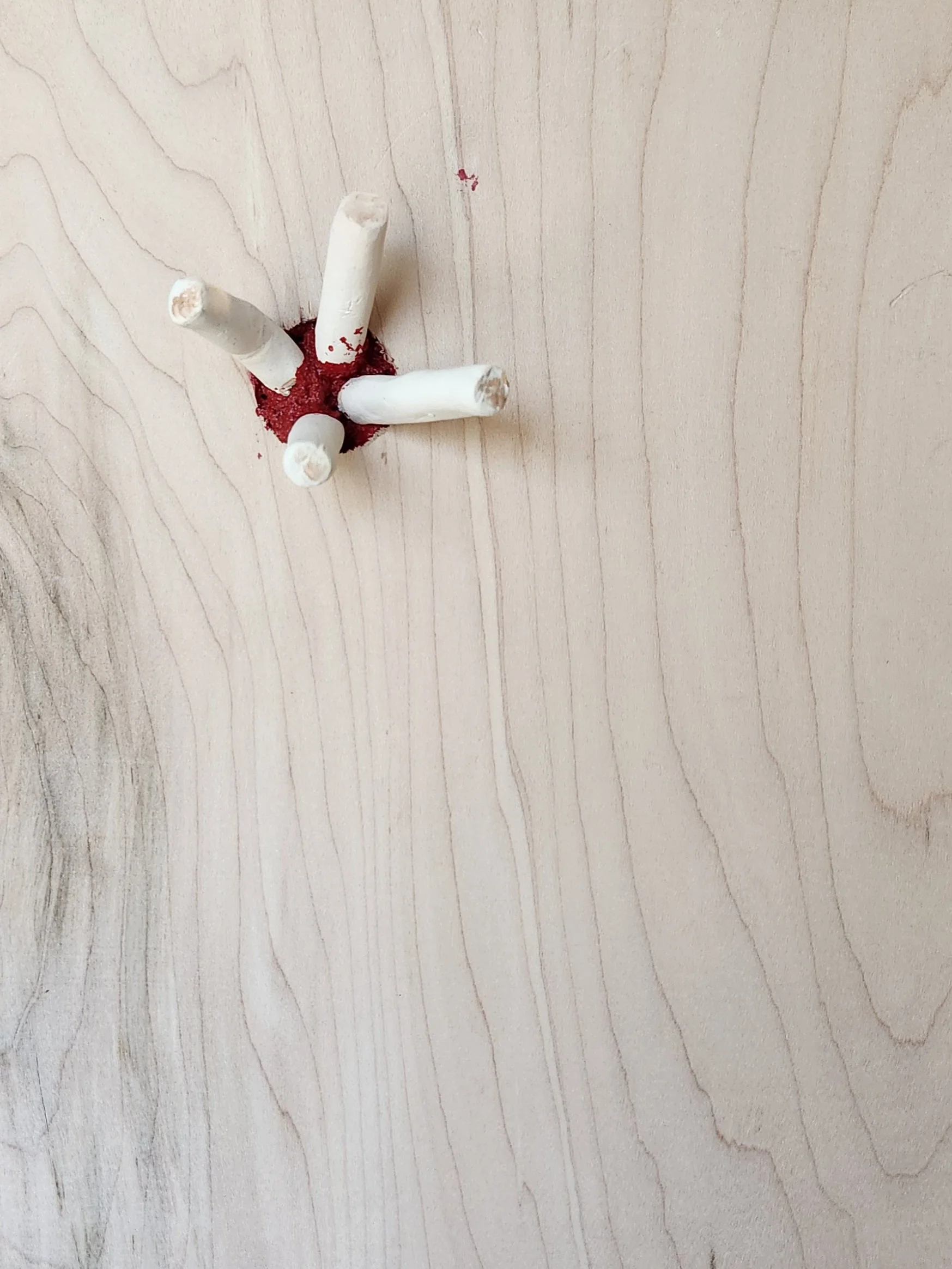 Ceramic cigarettes in wood panel