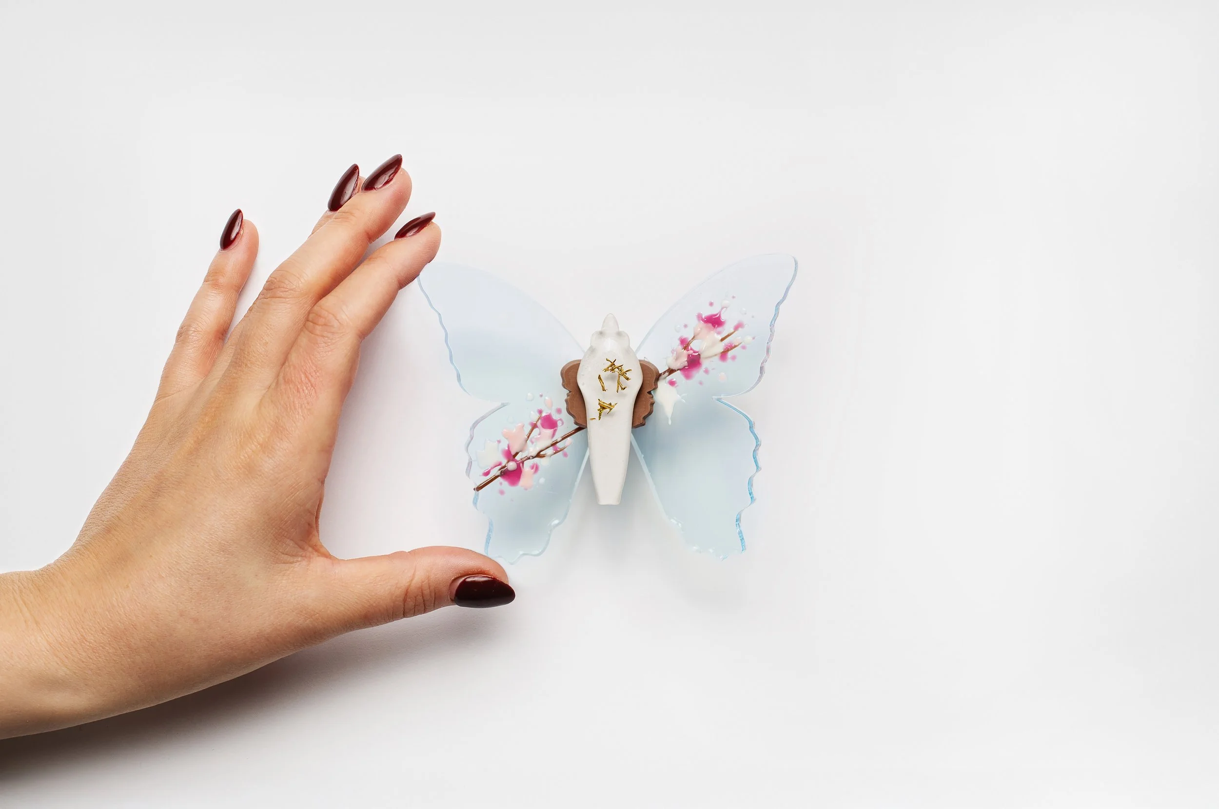 Miniature blue soft resin butterfly art featuring cherry blossoms representing the community affected by the Washington, D.C. mass shooting