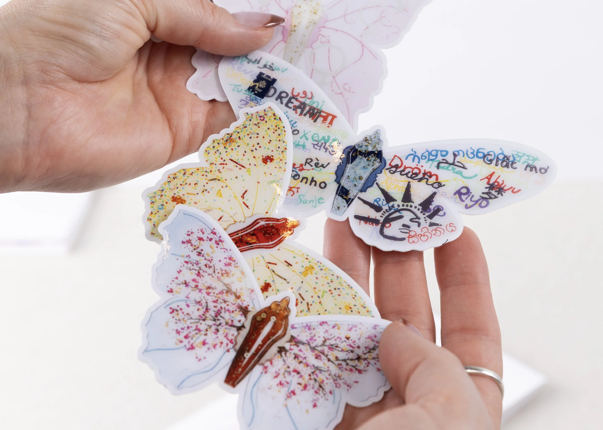 Close-up of colorful vinyl butterfly stickers featuring original artwork, intricate patterns, and vibrant designs from the Resilience collection.