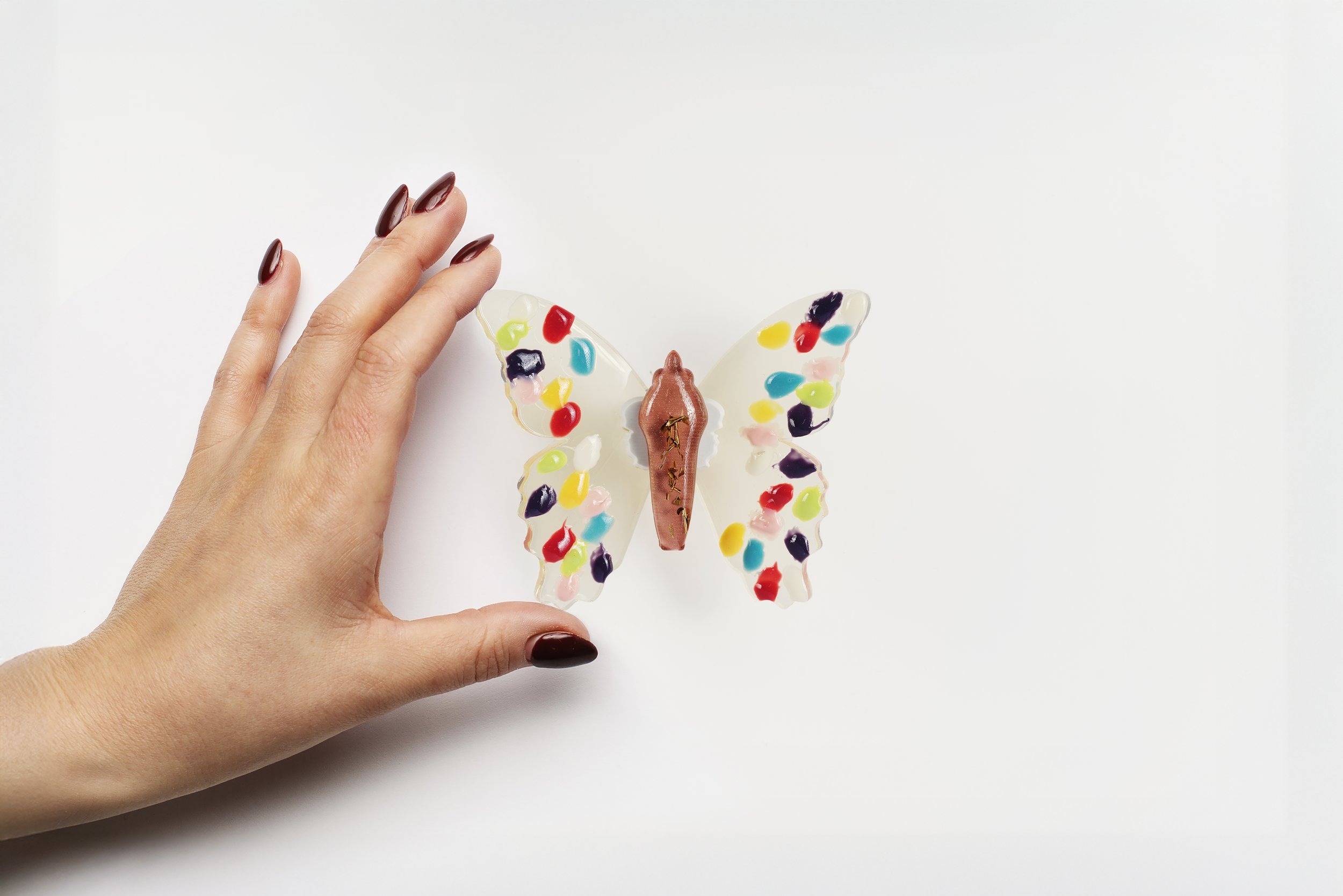 Miniature yellow soft resin butterfly art featuring fingerprints representing the community affected by the Sandy Hook Elementary School mass shooting in Newtown, CT