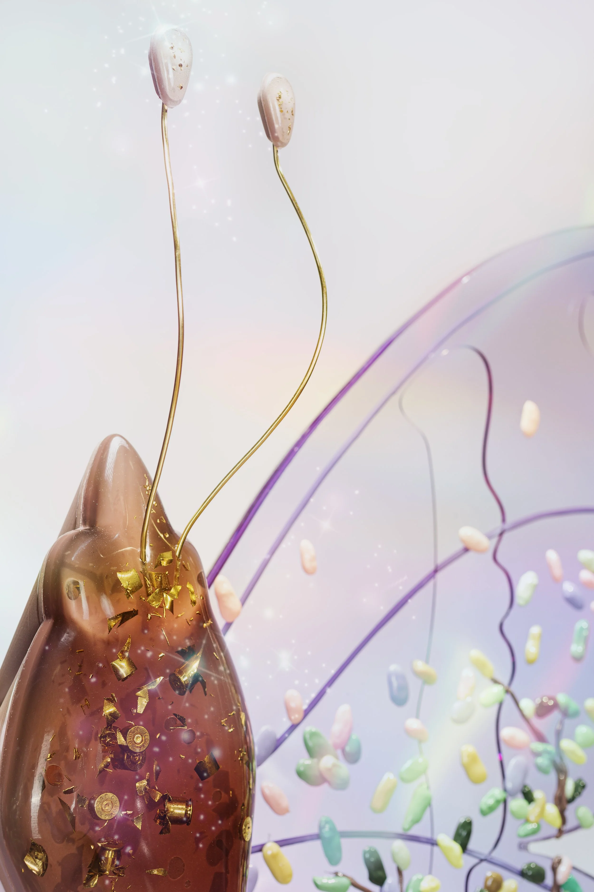 Close-up of a brown resin butterfly thorax with embedded shredded bullet casings and soft lavender wings.