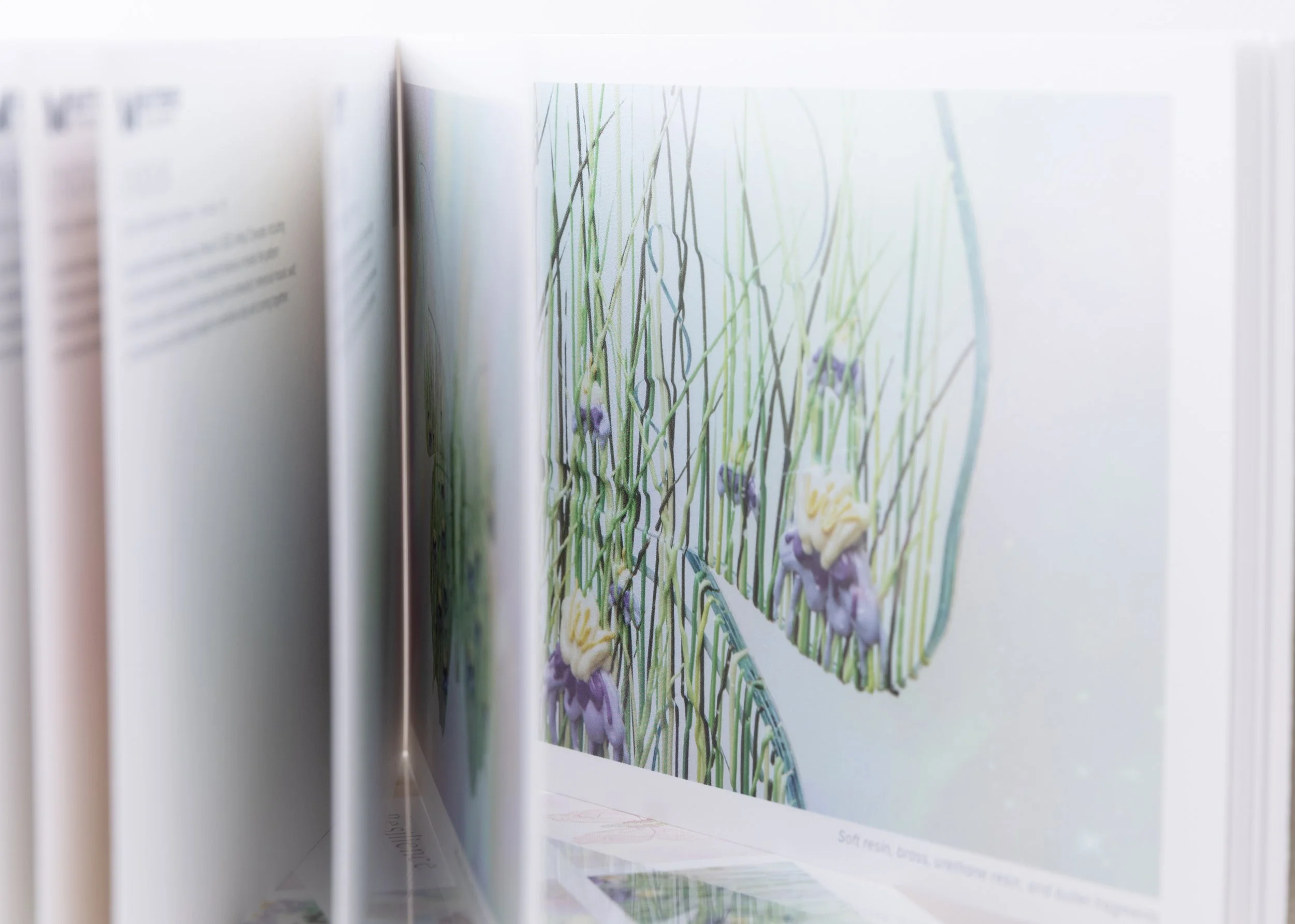 Interior pages of the Resilience Postcard Book featuring a detailed photograph of Blossom, a butterfly sculpture by Butterfly Art Collective.