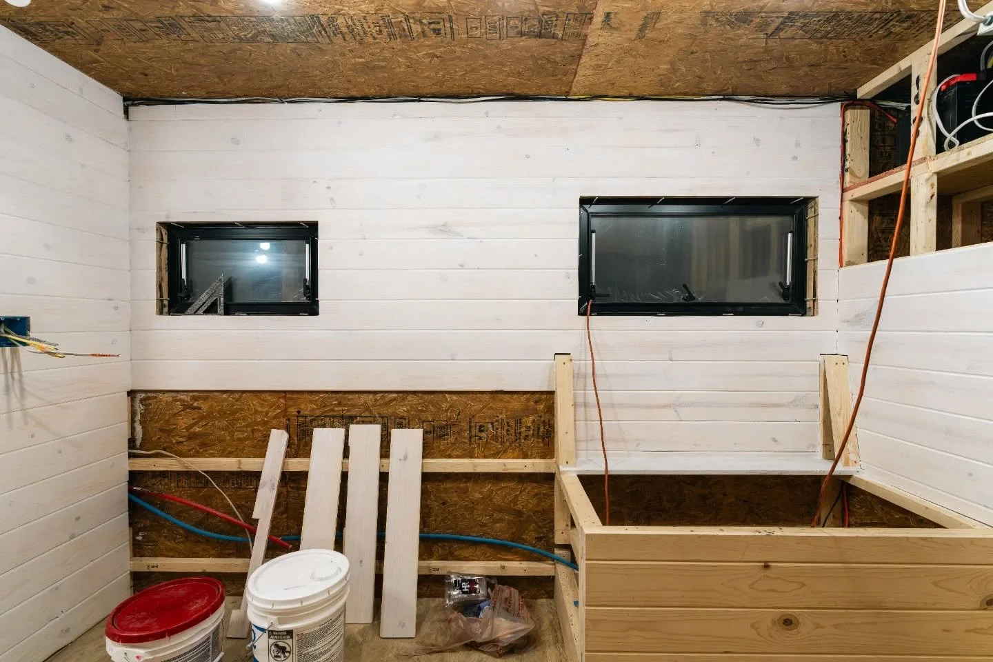 Tongue and groove wall boards provide extra insulation and sound dampening, but we wanted to reduce the woody-ness and brighten up the space with white paint. This is the first coat. Interior construction progress on our 1997 Stewart and Stevenson 6x