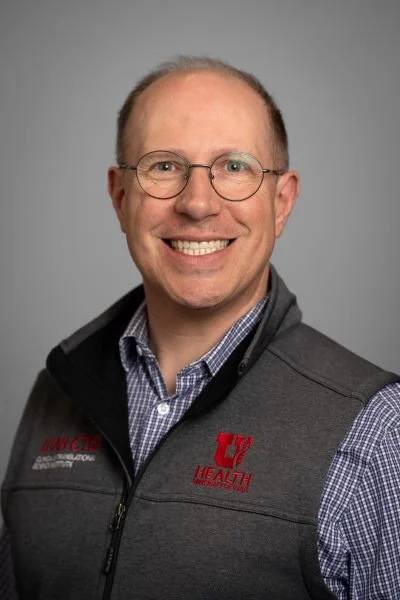 Generic avatar silhouette on a gray background.