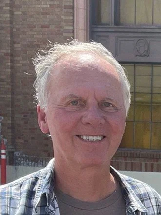 Generic user profile icon with a gray silhouette on a light background.