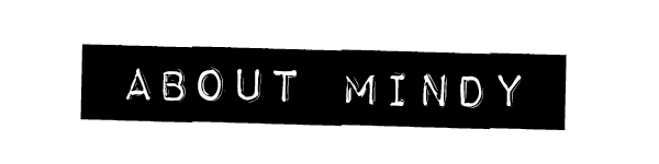 Text saying 'ABOUT MINDY' on a black background. Learn about singer-songwriter Mindy Gledhill's musical journey, albums, performances, and upcoming projects, inspiring self-acceptance and personal growth through her heartfelt music.