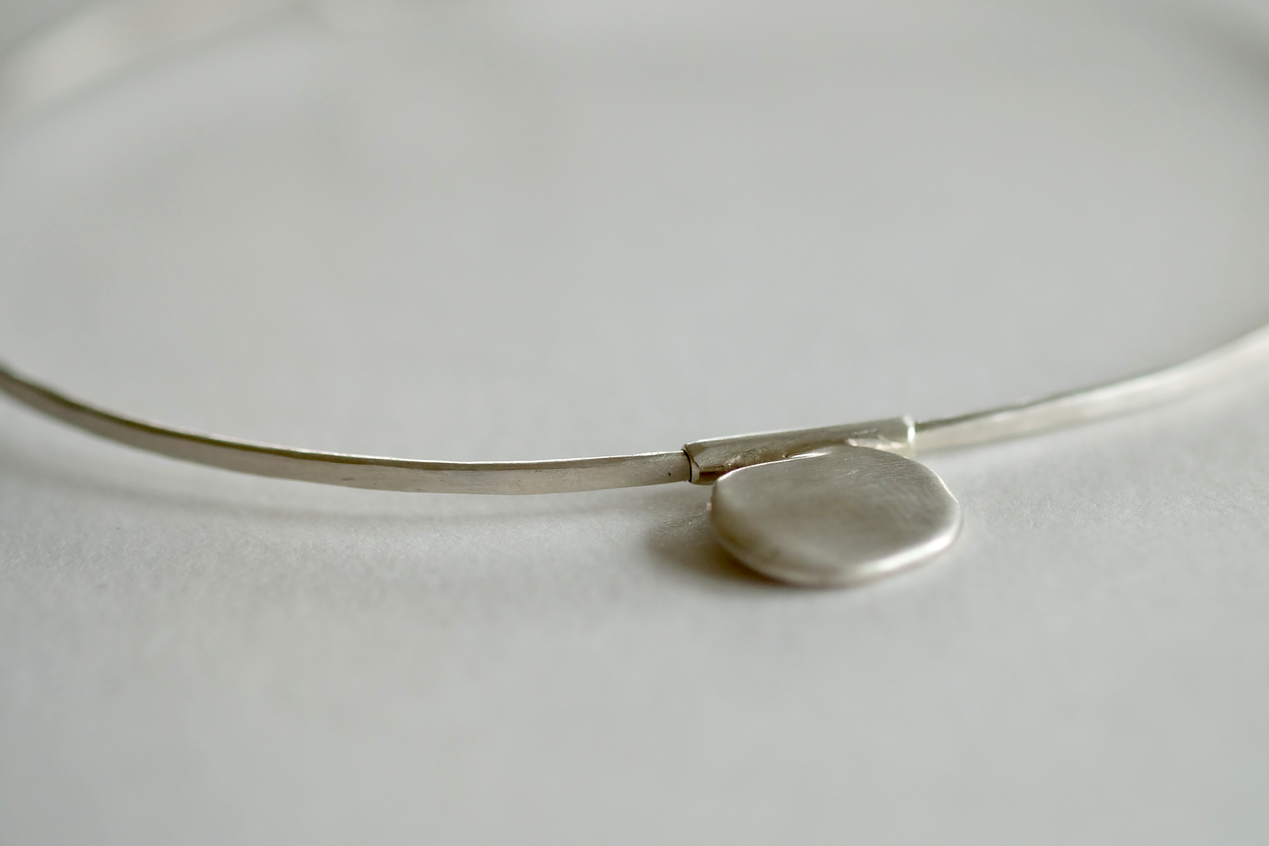Trail of Elephants_bracelet_disc_closeup.png