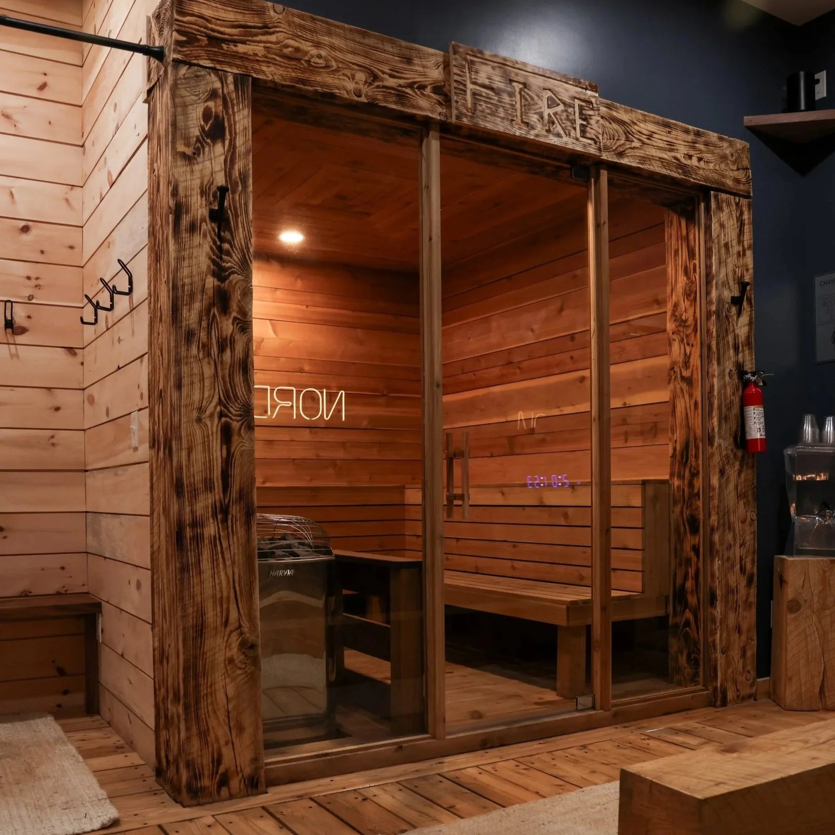 Fire sauna room with cedar interior, Harvia stone heater, and charred wood frame at Nordic on Nine in New Windsor NY