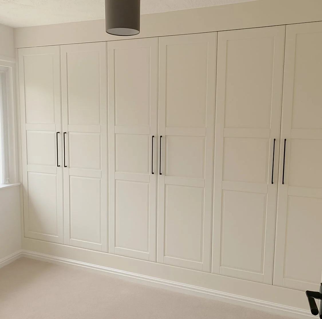 Built in floor to ceiling wardrobes wall to wall using ikea pax wardrobes.
