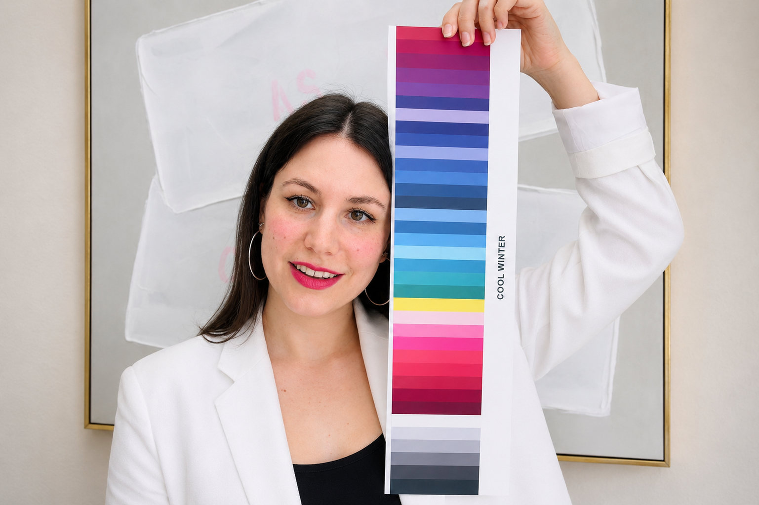 A woman holding a color swatch labeled 'Cool Winter' in front of a whiteboard.