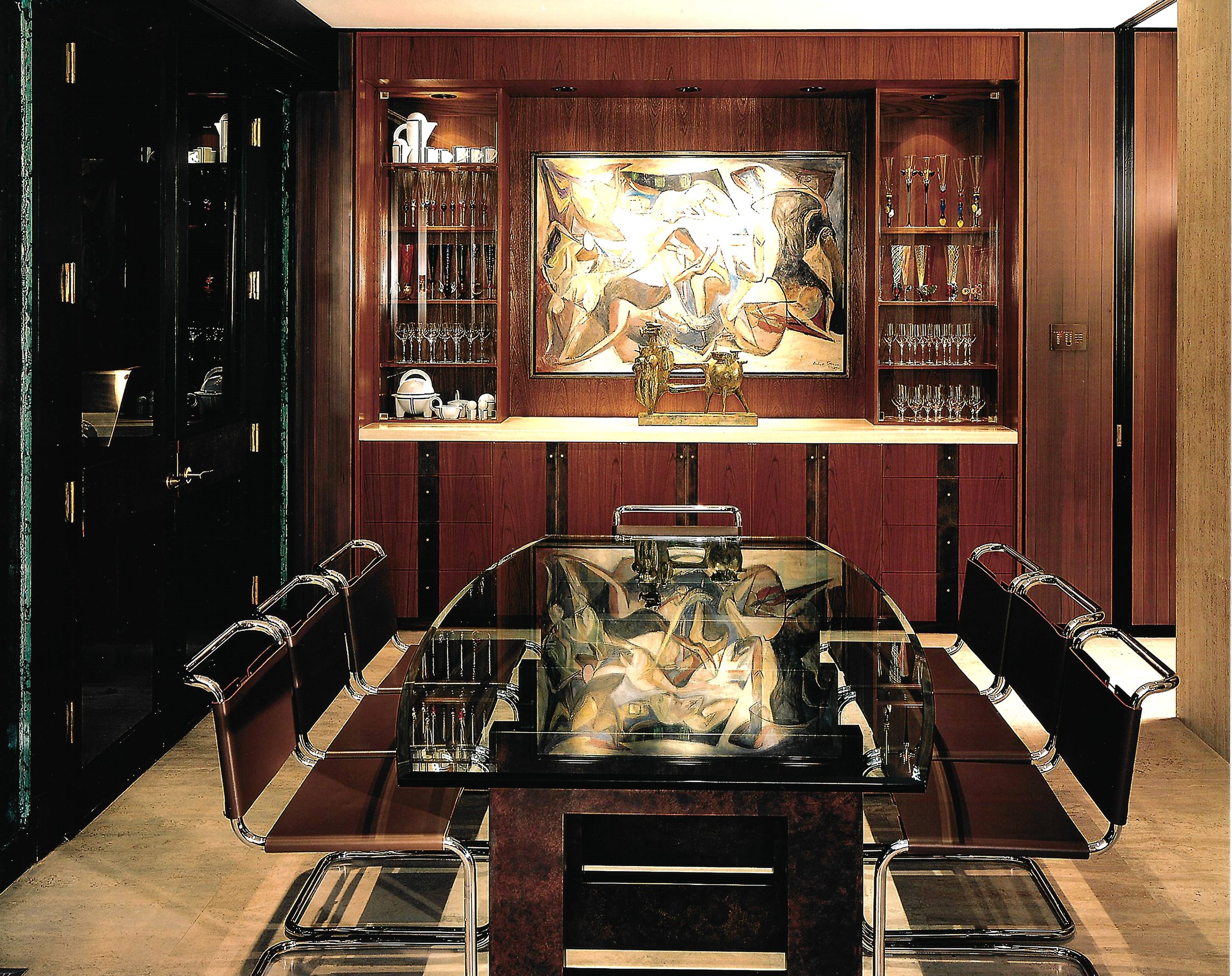 Modern dining room with glass-top table, eight chairs, abstract art, and wooden cabinets with glassware.