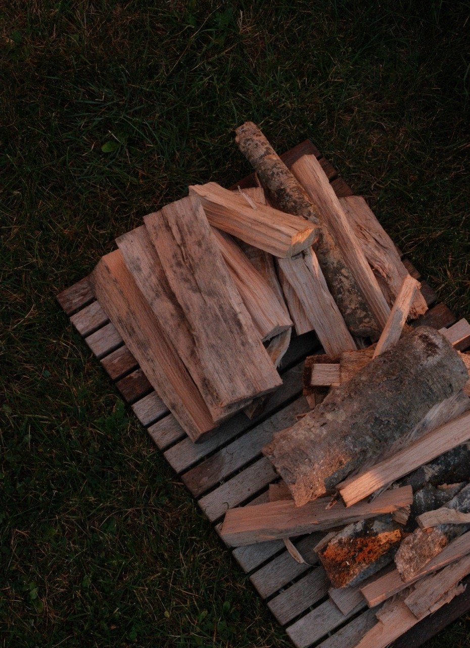 Firewood logs stacked on a pallet, ready to be burned.