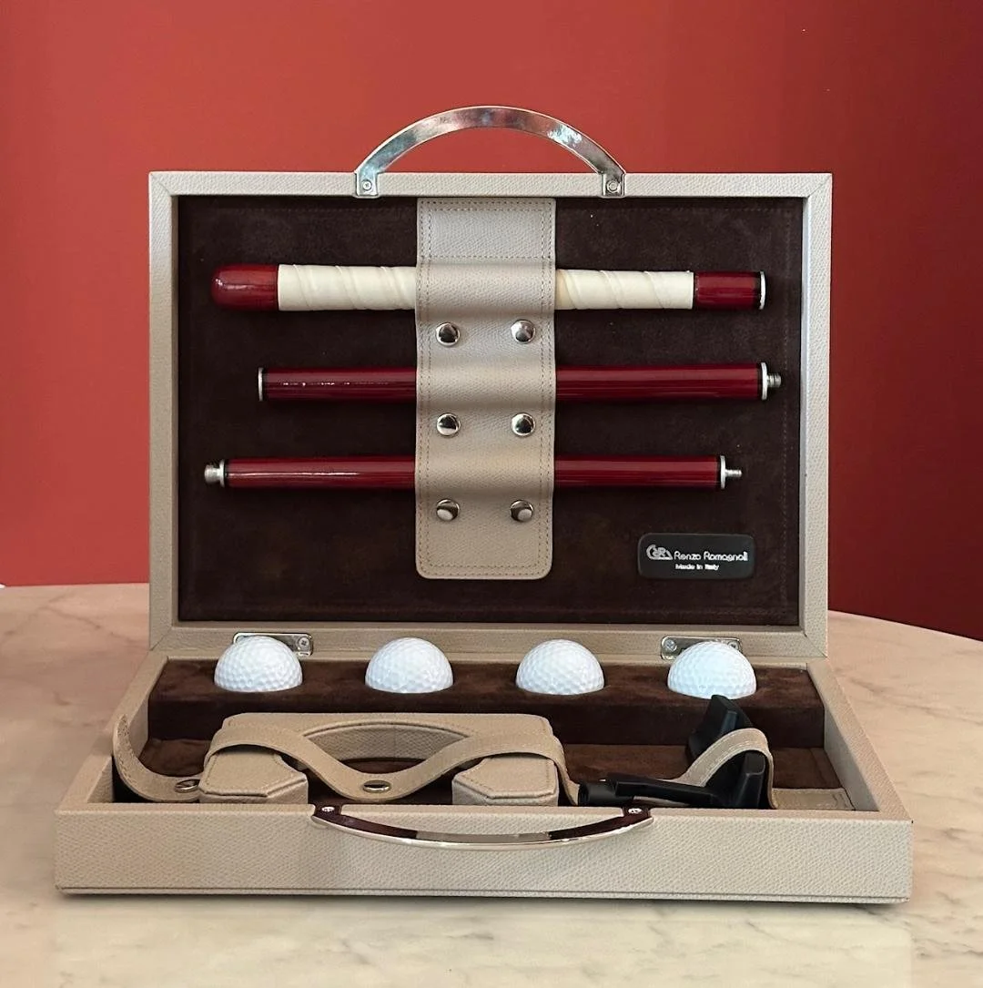 Italian leather custom golf set for the office in a beige case with golf balls, golf tees, and practice golf clubs.